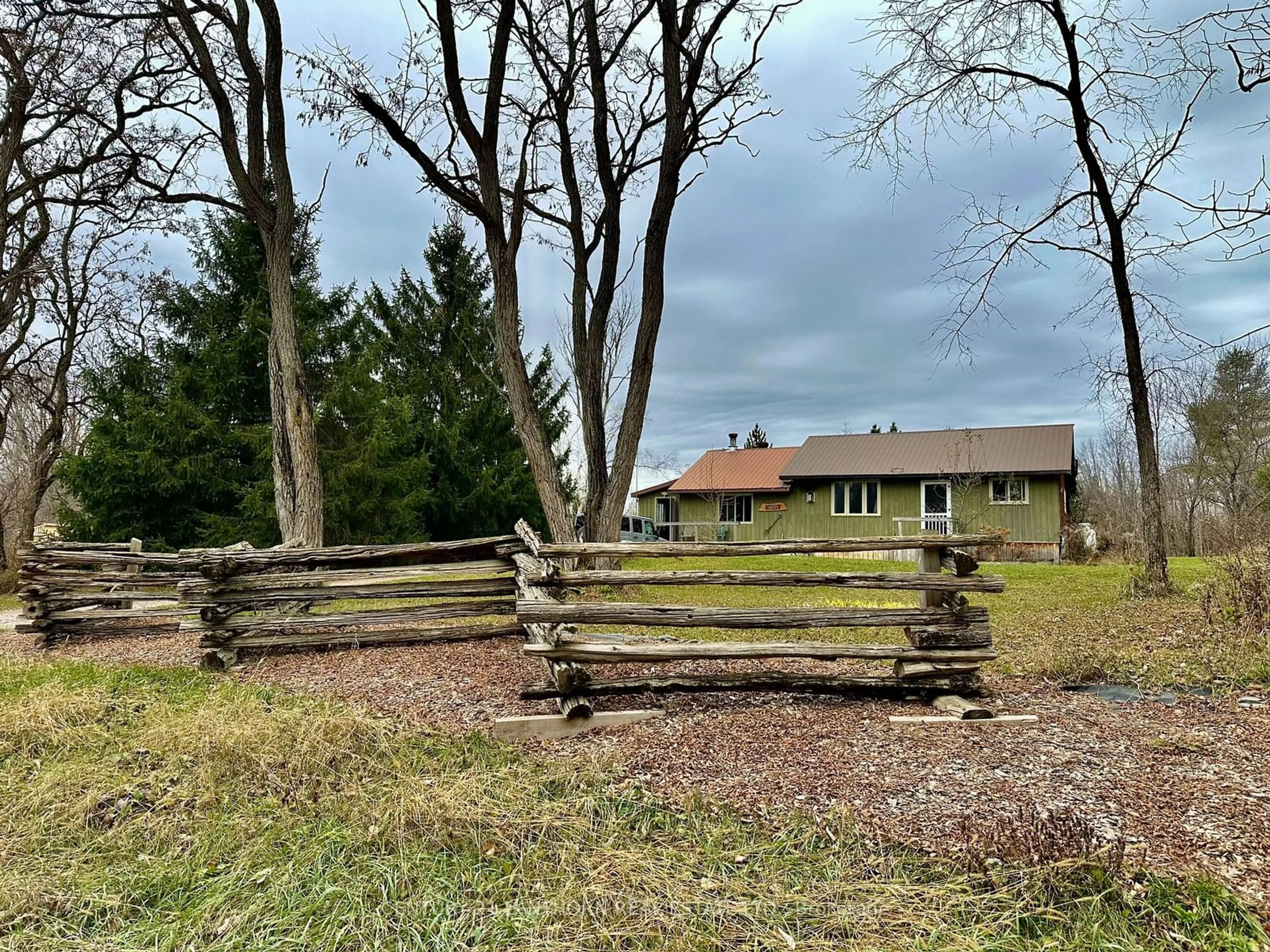 Frontside or backside of a home, the fenced backyard for 589 Wolf Lake Rd, Madoc Ontario K0K 1Y0