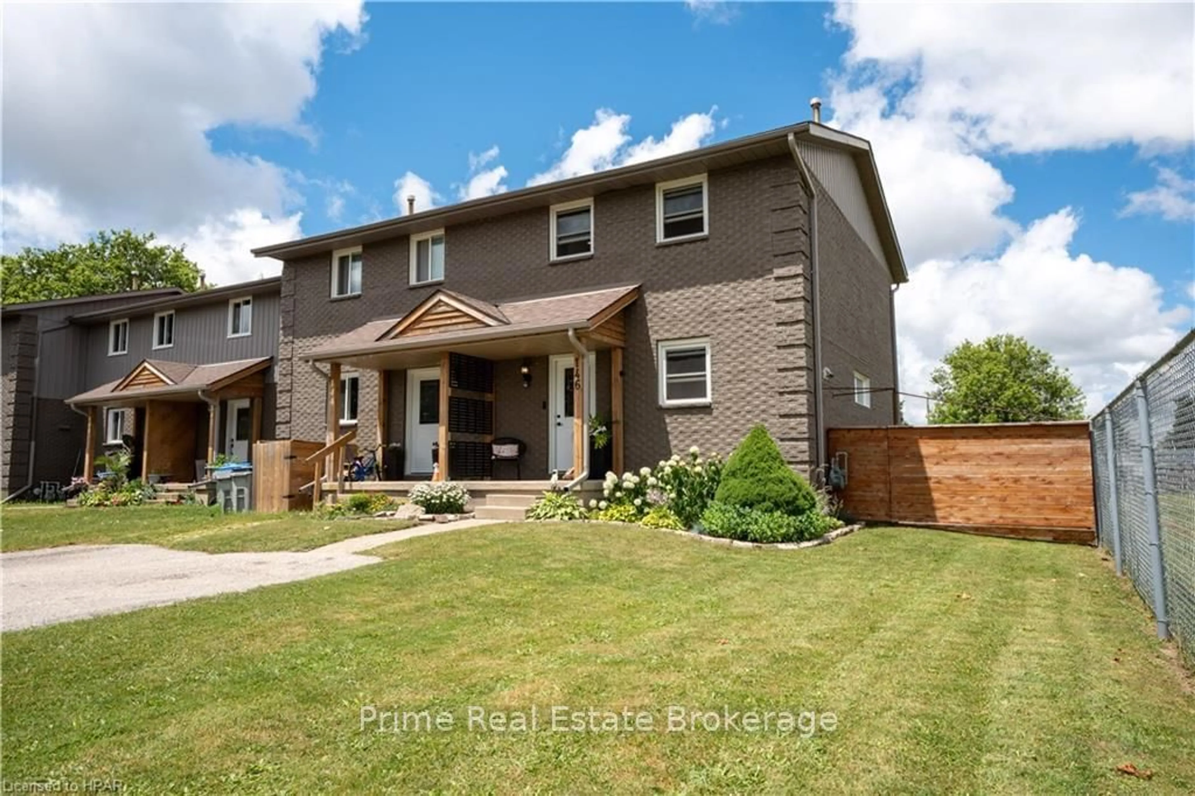 Frontside or backside of a home, the fenced backyard for 146 SIMCOE St, South Huron Ontario N0M 1S1