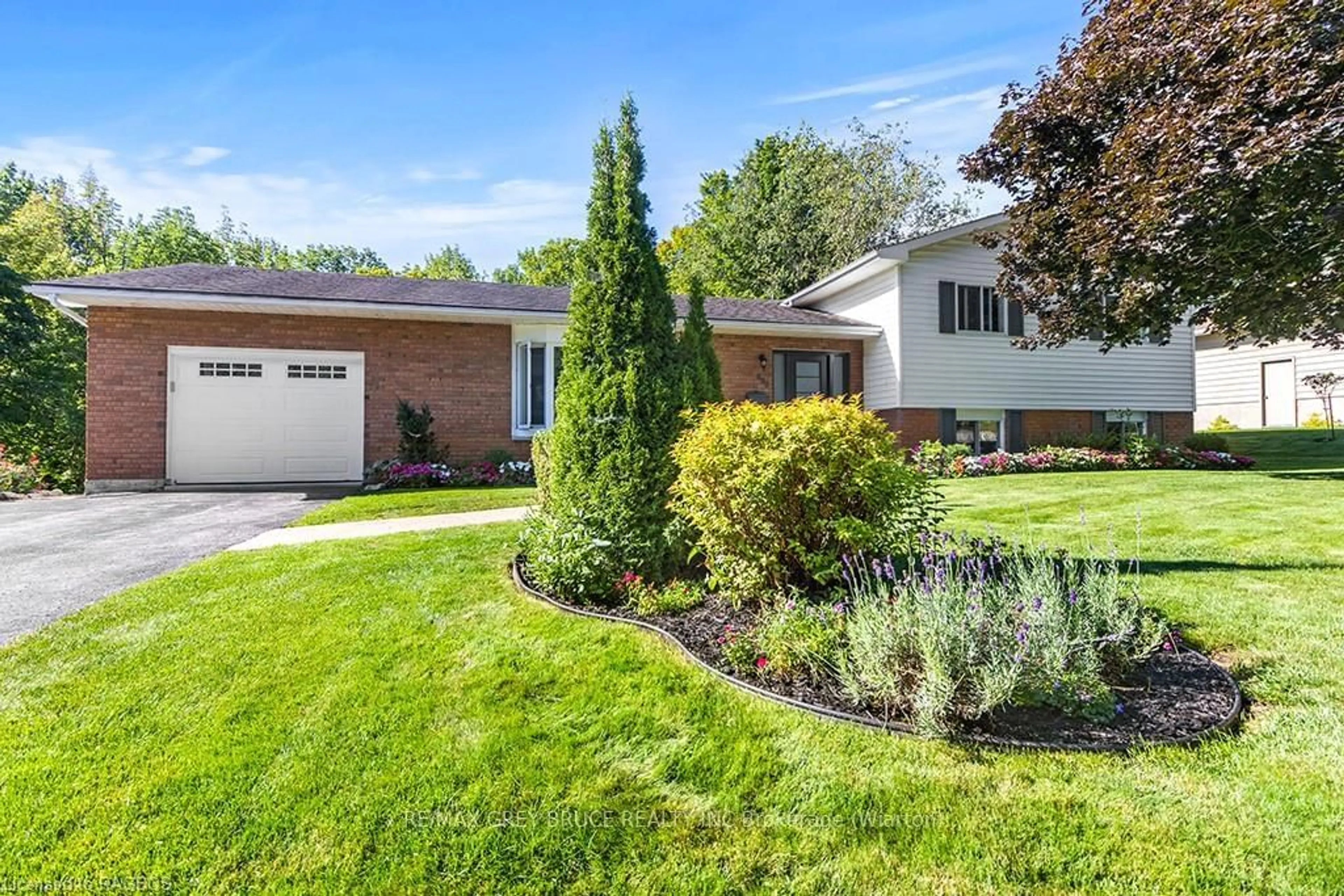 Frontside or backside of a home, the fenced backyard for 699 20TH St, Owen Sound Ontario N4K 4E1