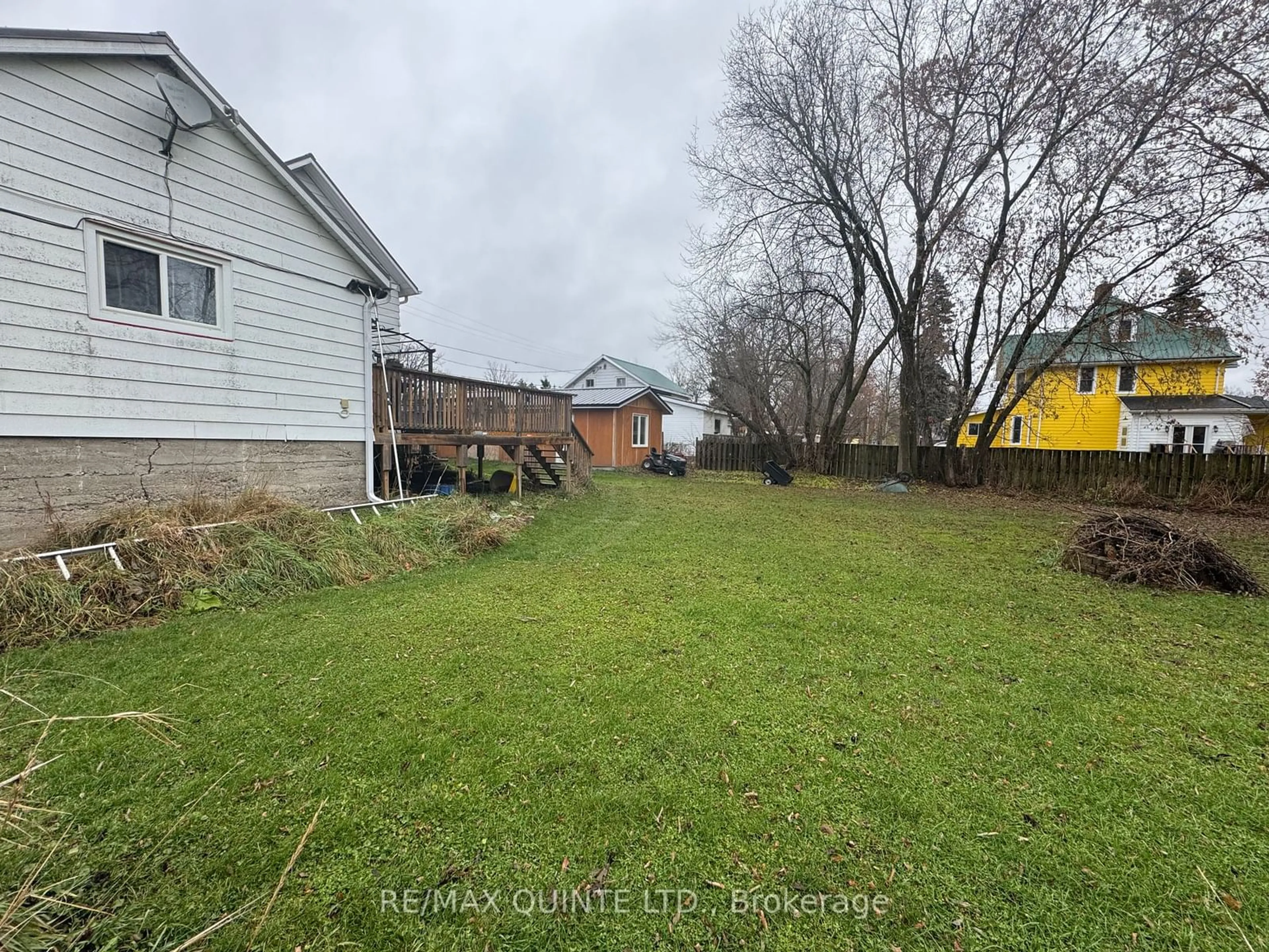 Frontside or backside of a home, the fenced backyard for 22 Wellington St, Centre Hastings Ontario K0K 2K0