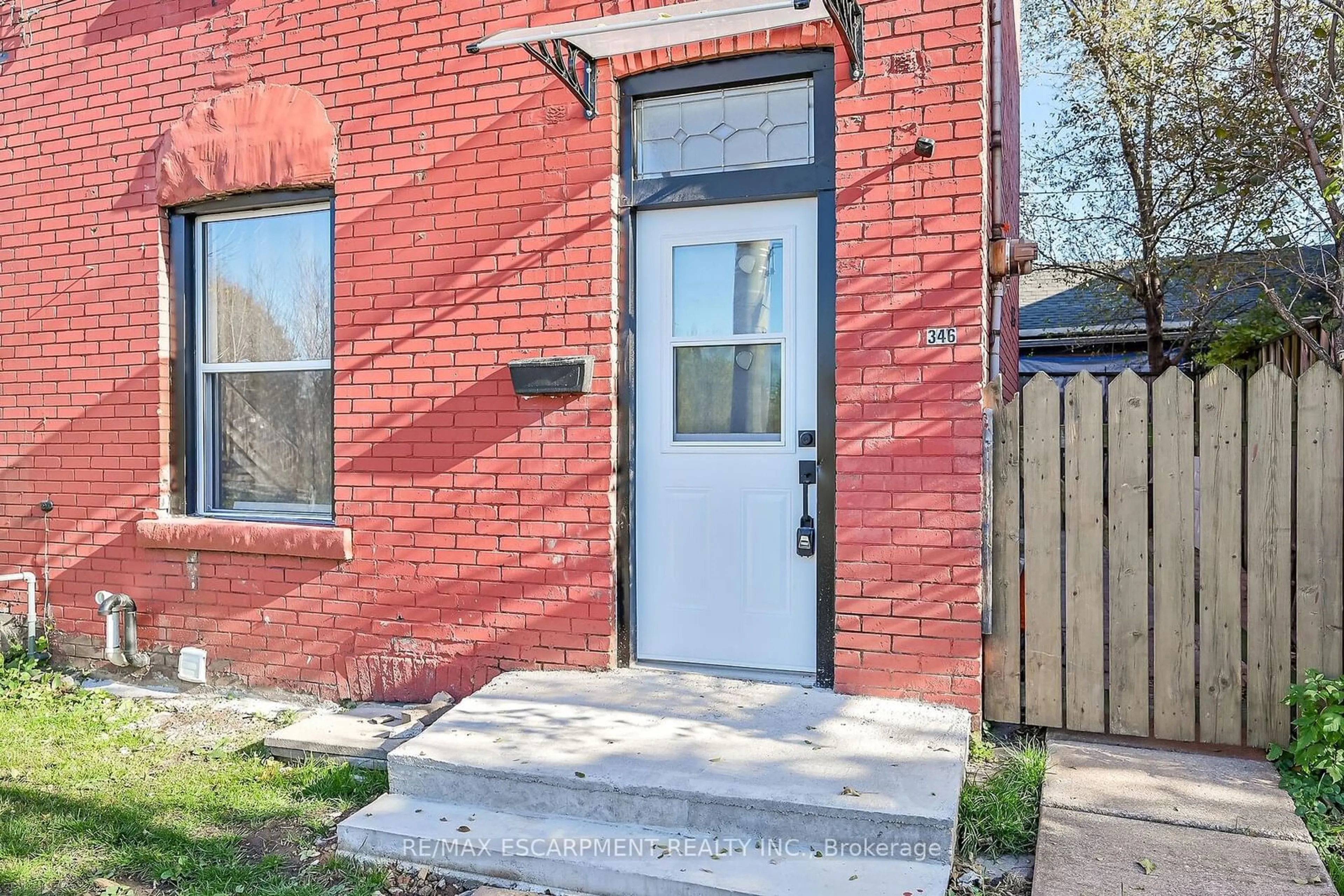 A pic from exterior of the house or condo, the fenced backyard for 346 Emerald St, Hamilton Ontario L8L 5L4