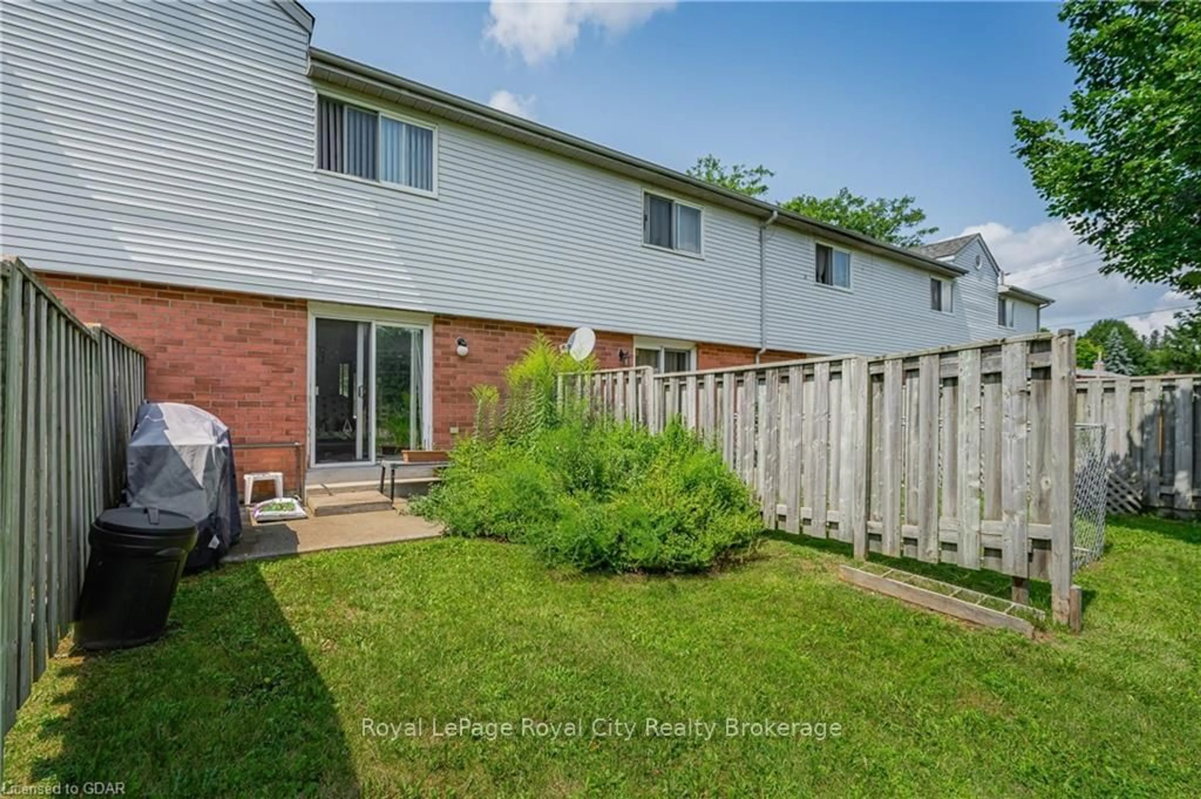 A pic from exterior of the house or condo, the fenced backyard for 40 IMPERIAL Rd #5, Guelph Ontario N1H 8B4