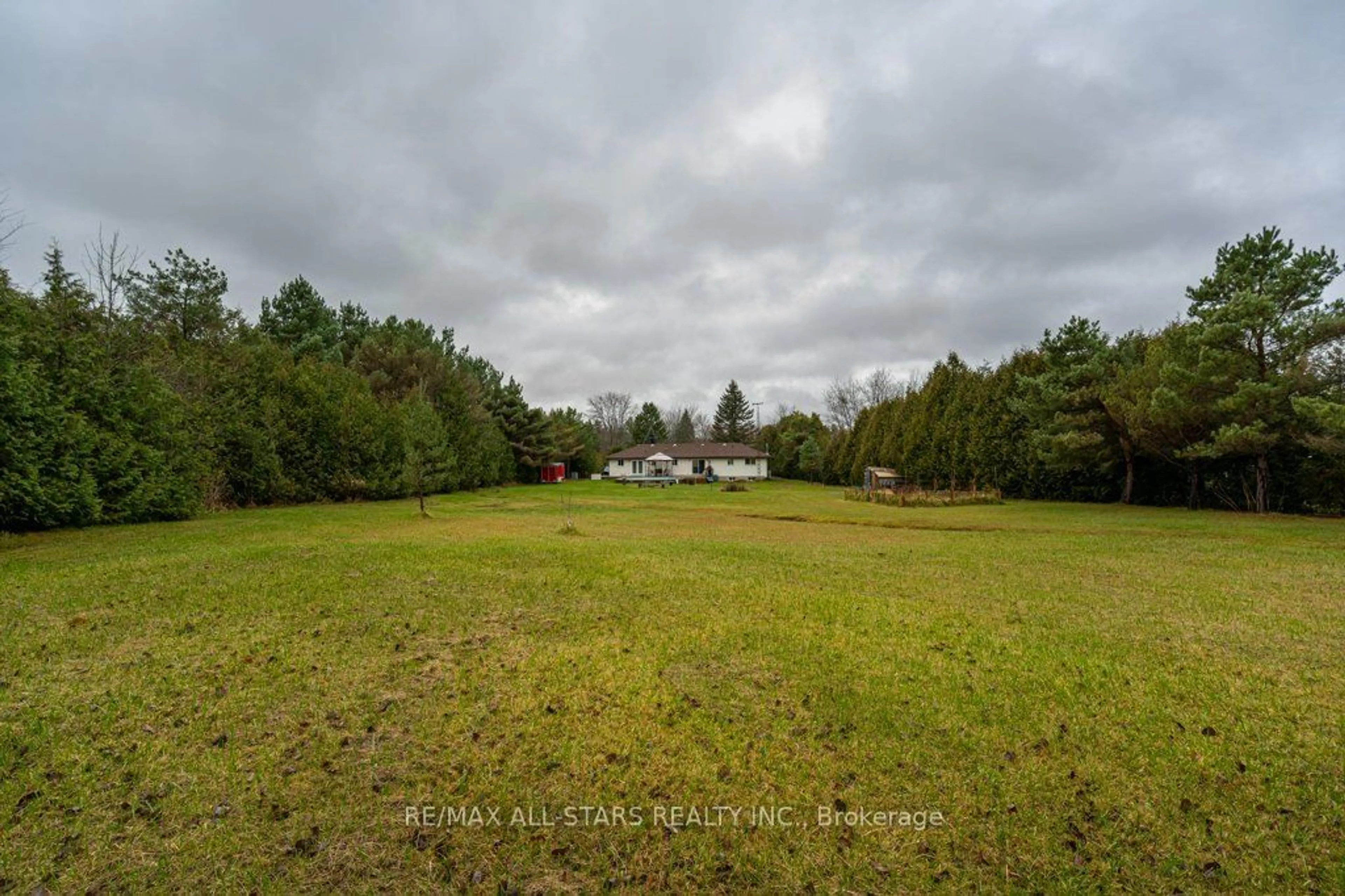 Frontside or backside of a home, the fenced backyard for 32 Kenedon Dr, Kawartha Lakes Ontario K0L 2W0