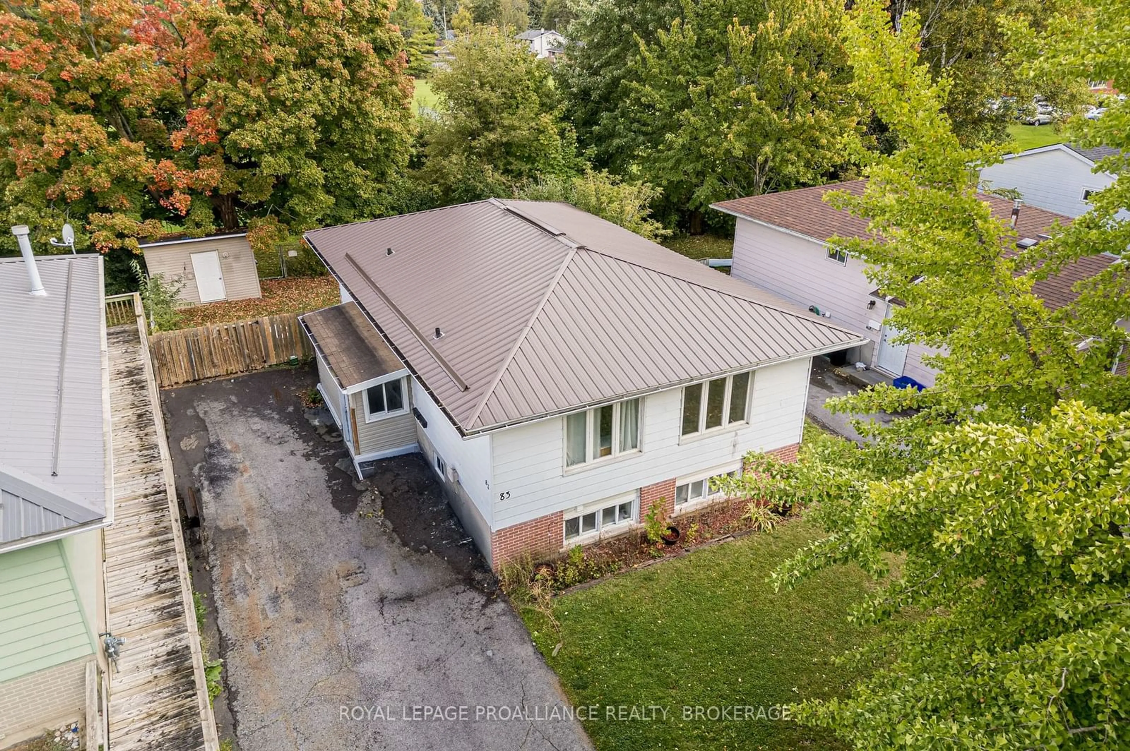 Frontside or backside of a home, the fenced backyard for 83 Calderwood Dr, Kingston Ontario K7M 6L5