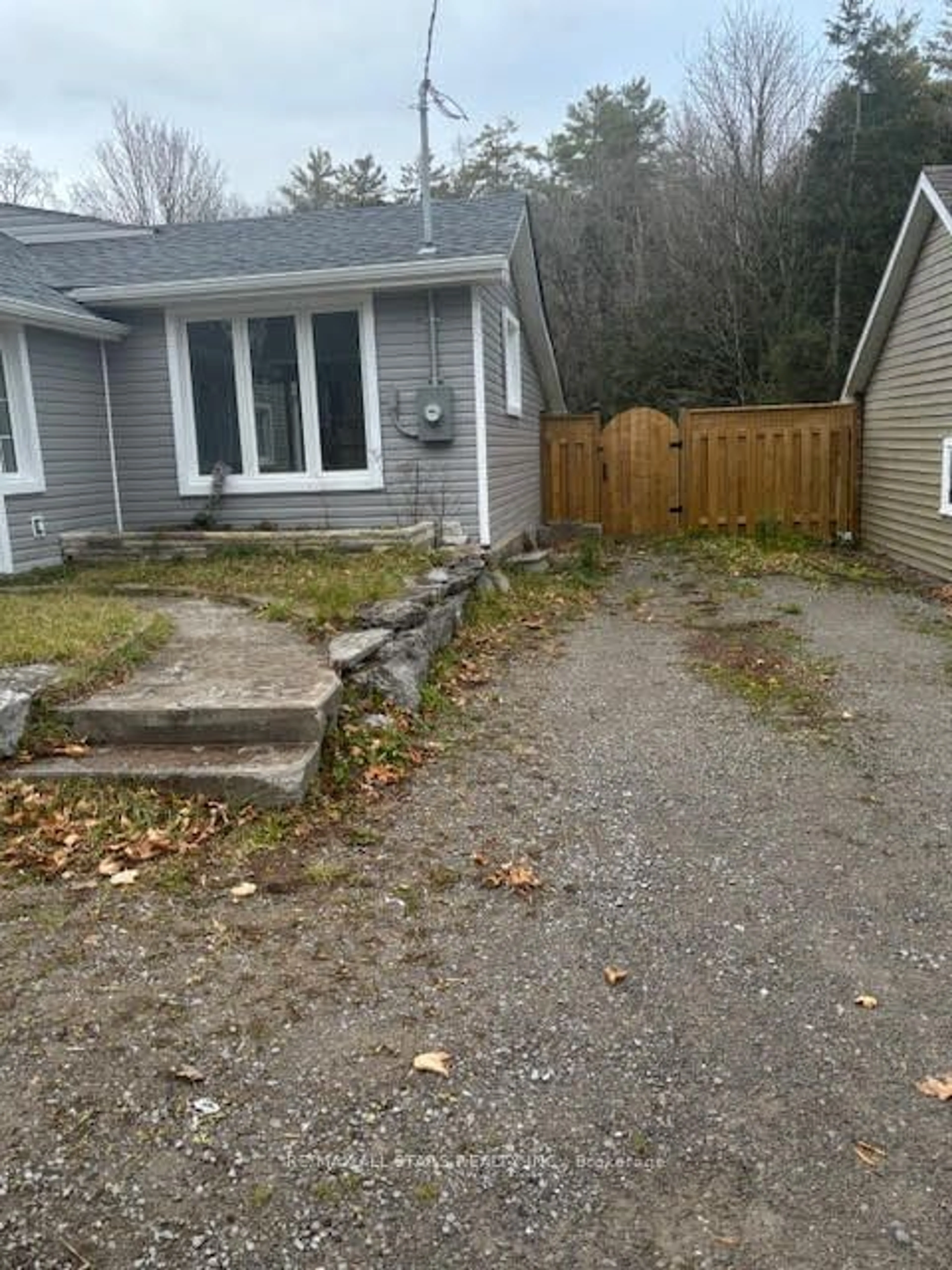 Frontside or backside of a home, the fenced backyard for 16 Lime St, Kawartha Lakes Ontario K0M 1K0