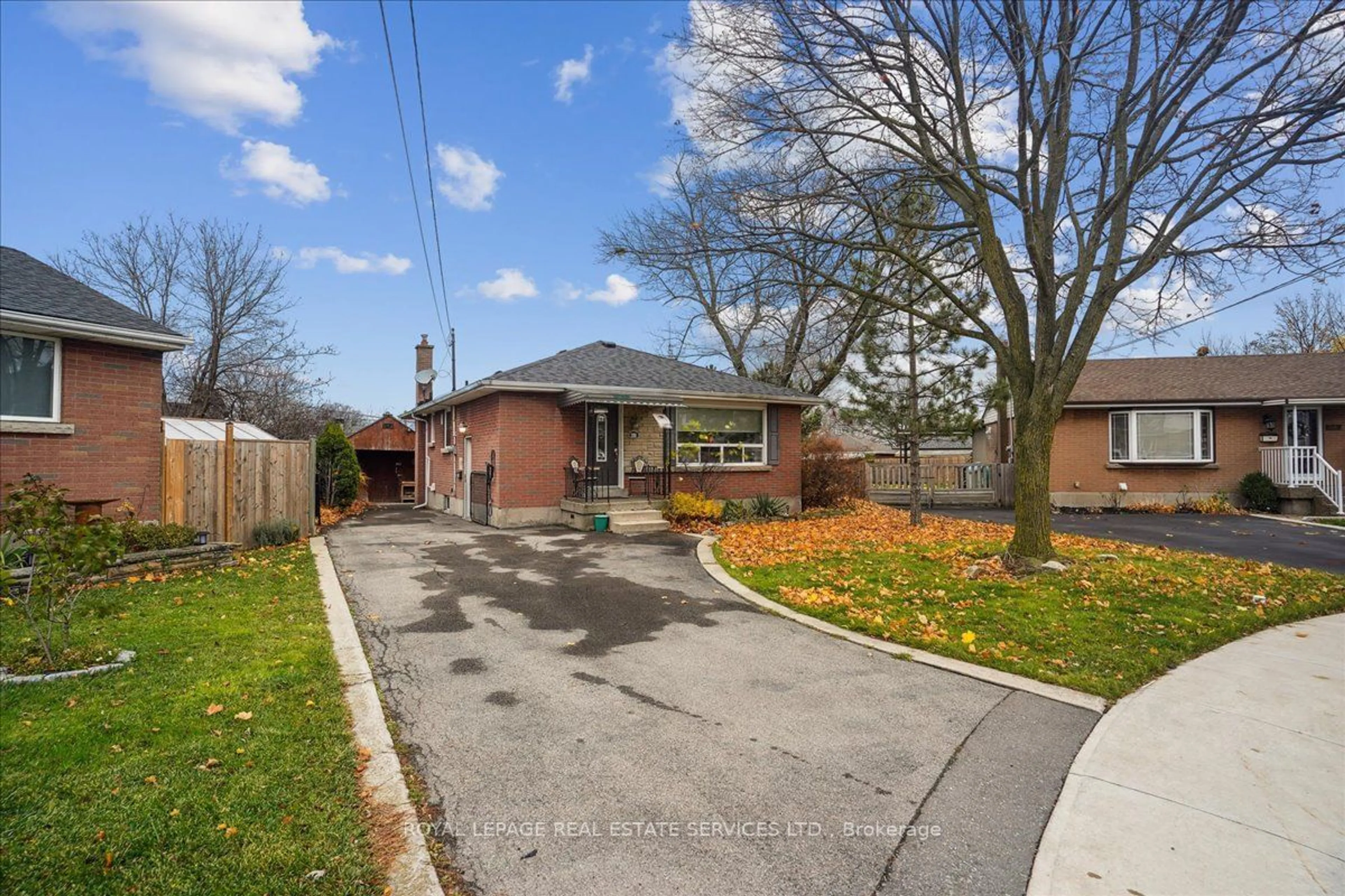 Frontside or backside of a home, the fenced backyard for 391 East 16th St, Hamilton Ontario L9A 4K4