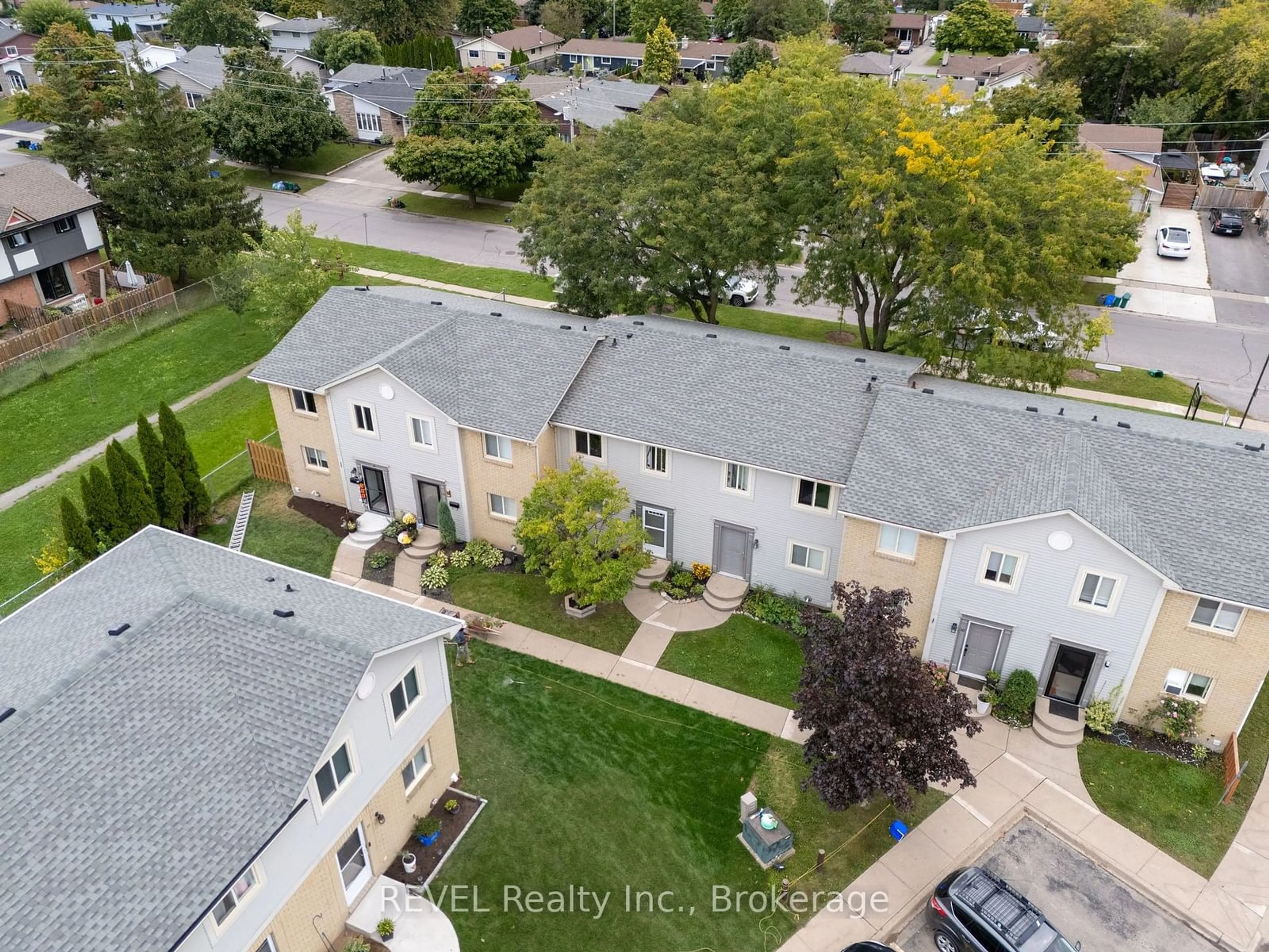 A pic from exterior of the house or condo, the fenced backyard for 65 Dorchester Blvd #12, St. Catharines Ontario L2M 7T3