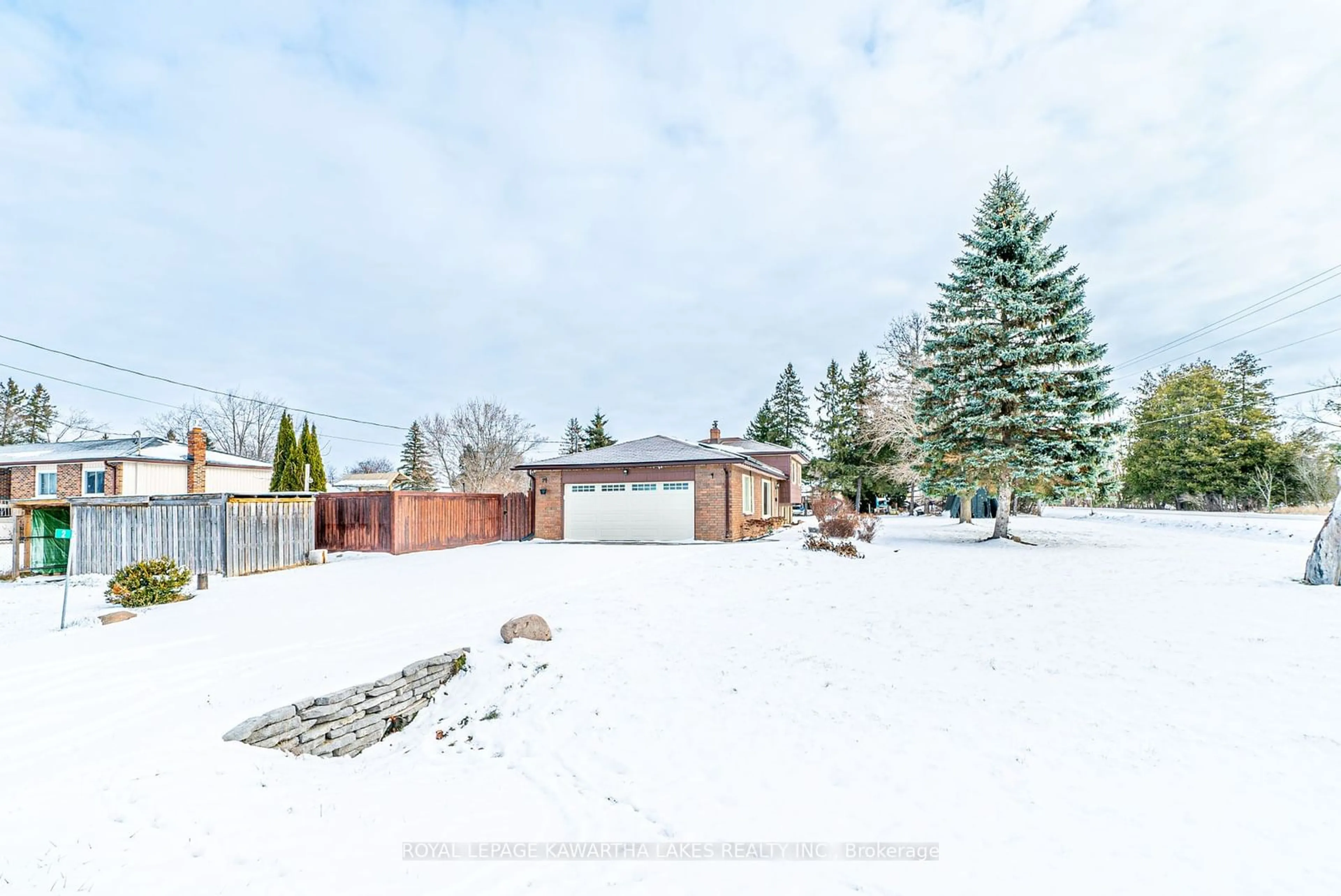 Frontside or backside of a home, the fenced backyard for 2 Maxwell St, Kawartha Lakes Ontario K0M 1L0