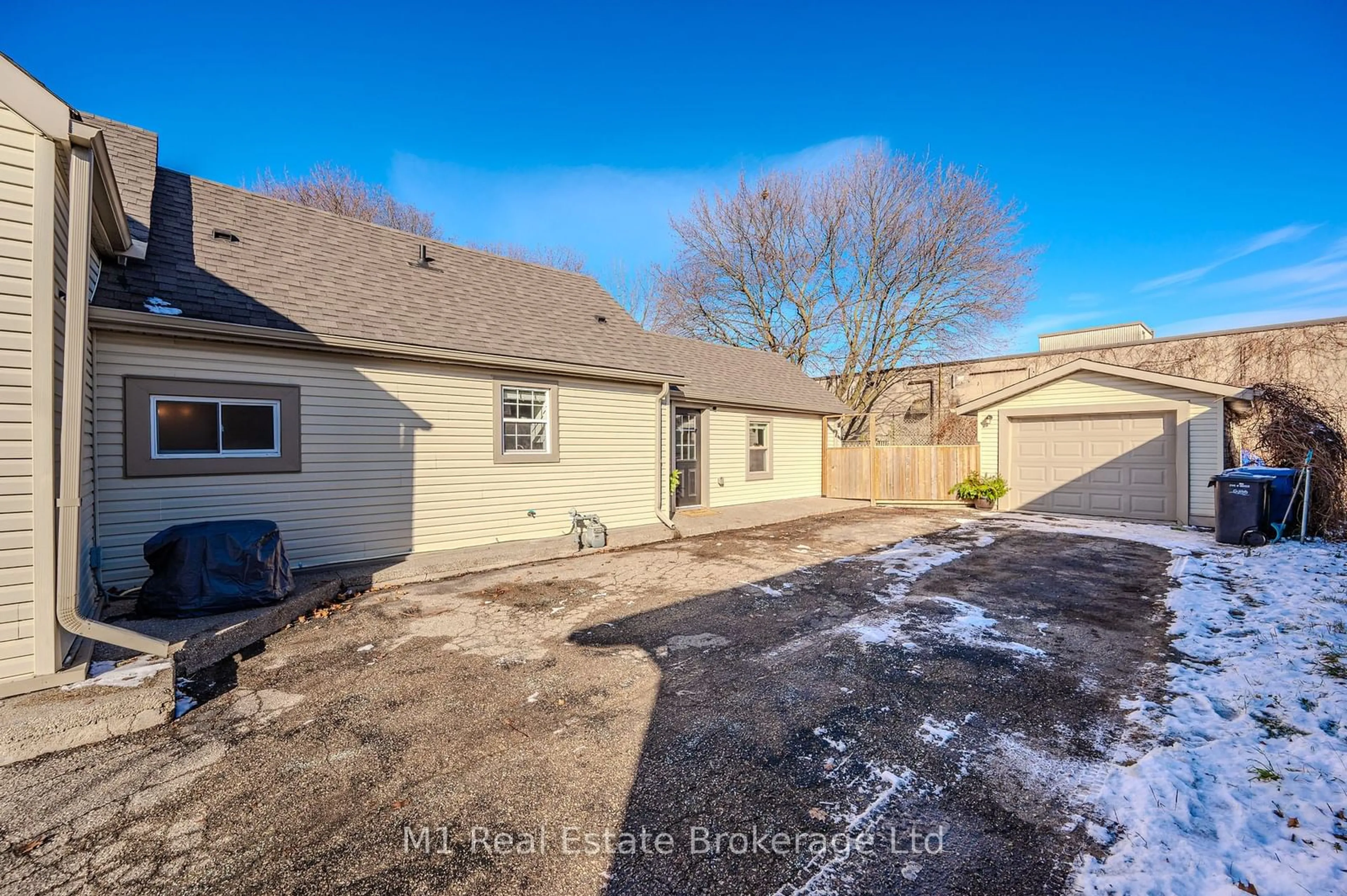 Frontside or backside of a home, the fenced backyard for 16 Hooper St, Guelph Ontario N1E 5W5