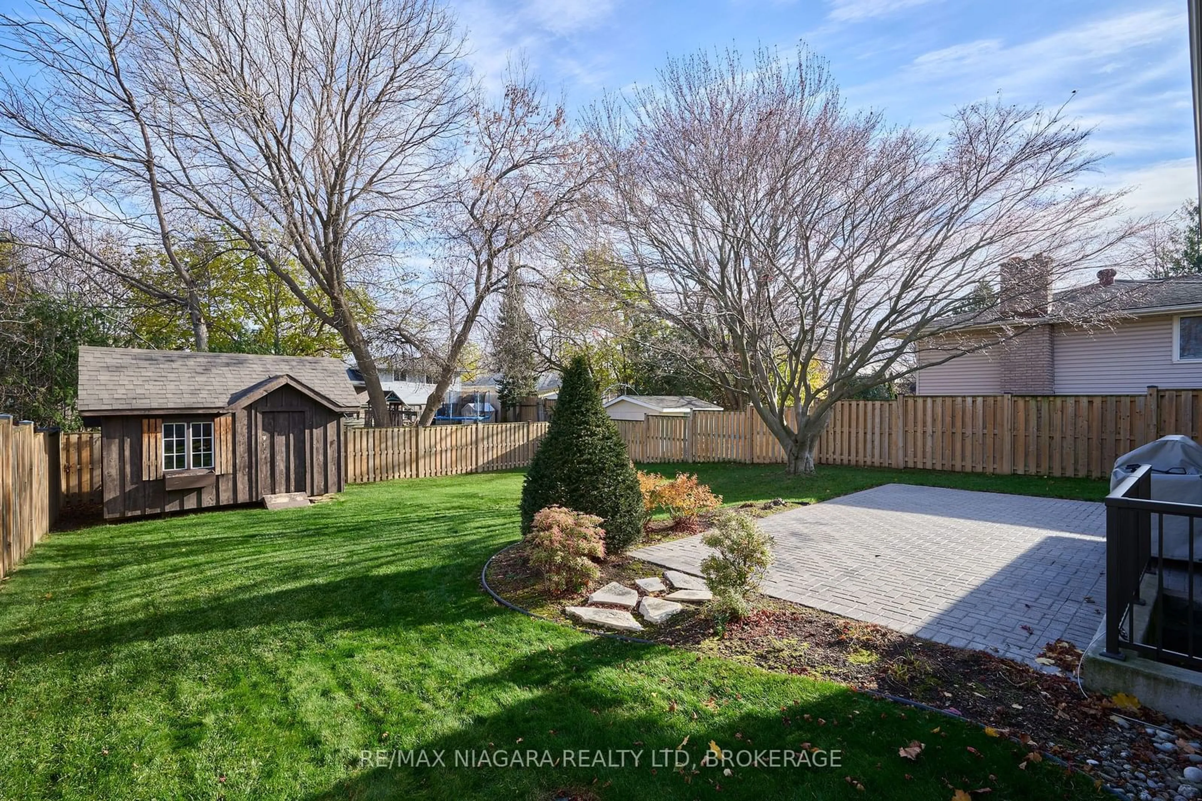 Frontside or backside of a home, the fenced backyard for 100 Sherman Dr, St. Catharines Ontario L2N 2L5