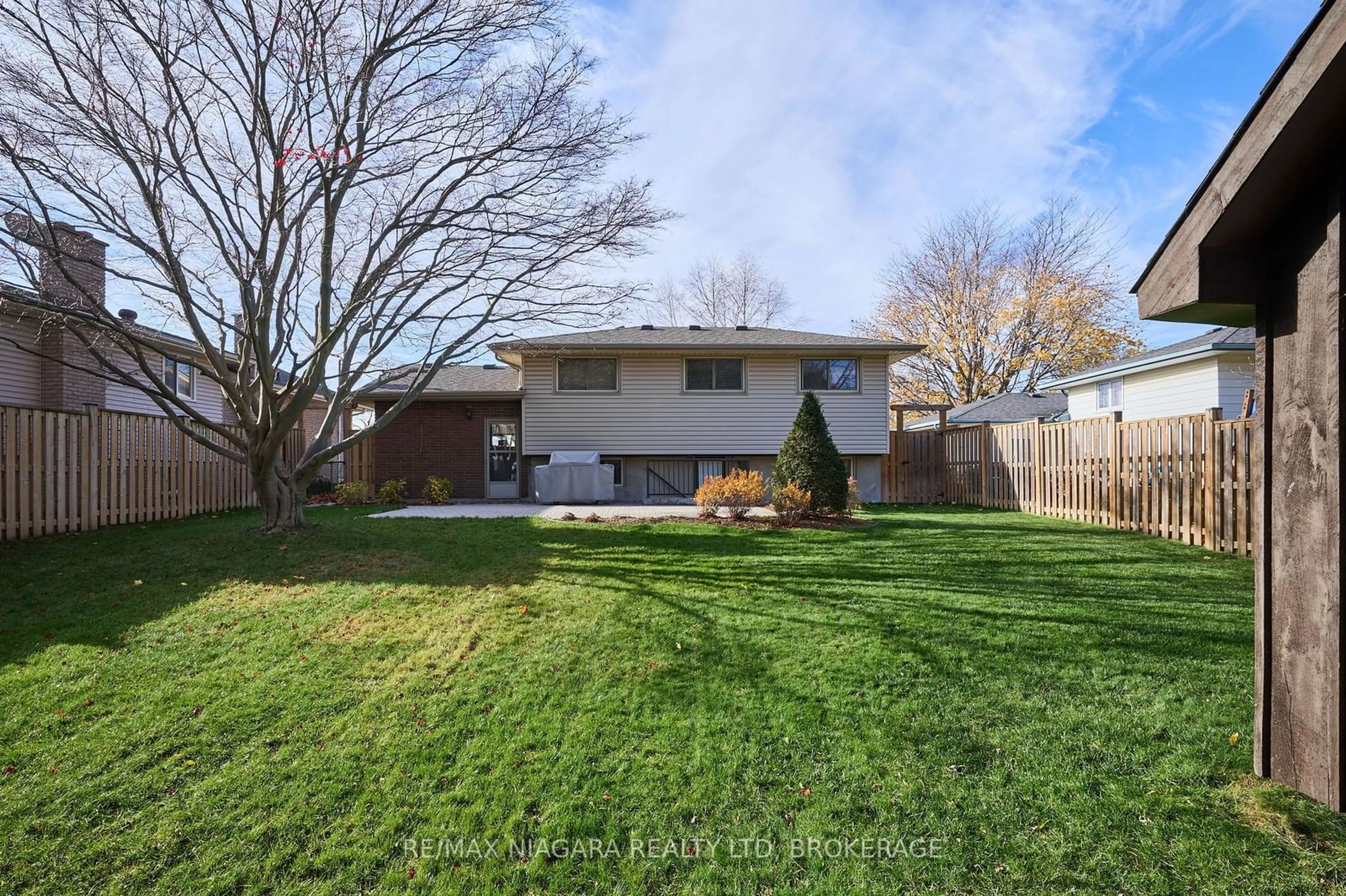 Frontside or backside of a home, the fenced backyard for 100 Sherman Dr, St. Catharines Ontario L2N 2L5