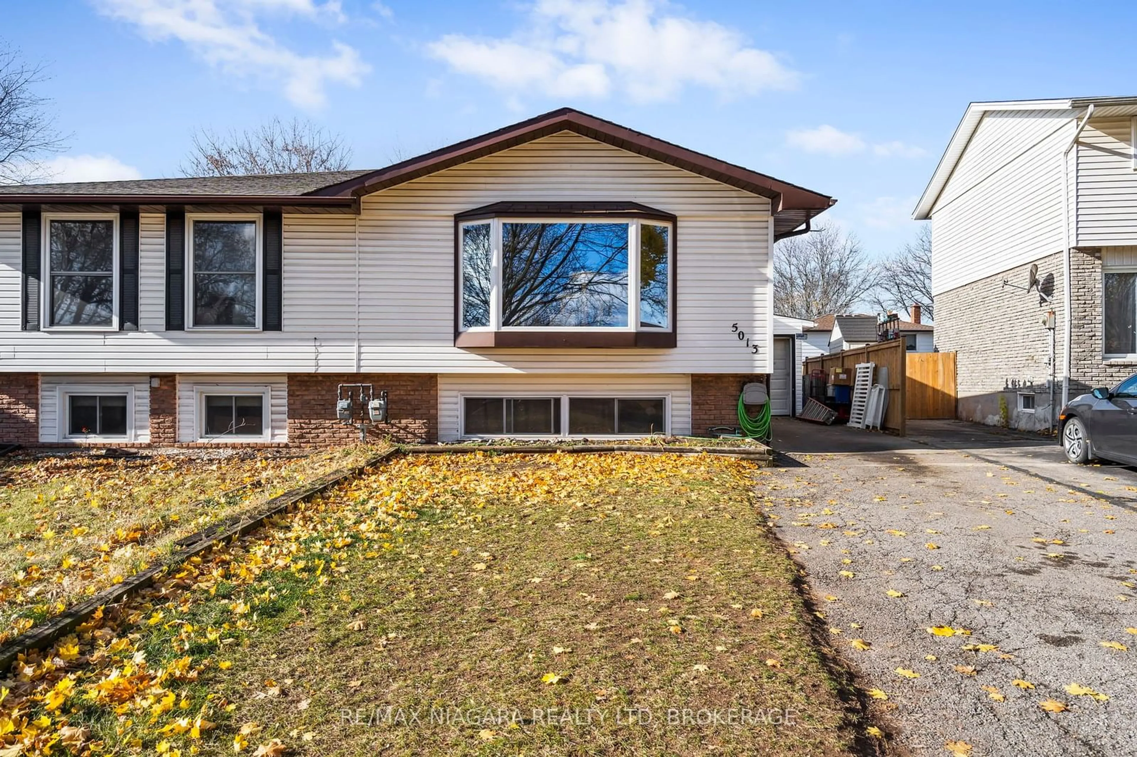 Frontside or backside of a home, the fenced backyard for 5013 Gage Crt, Niagara Falls Ontario L2E 7B5