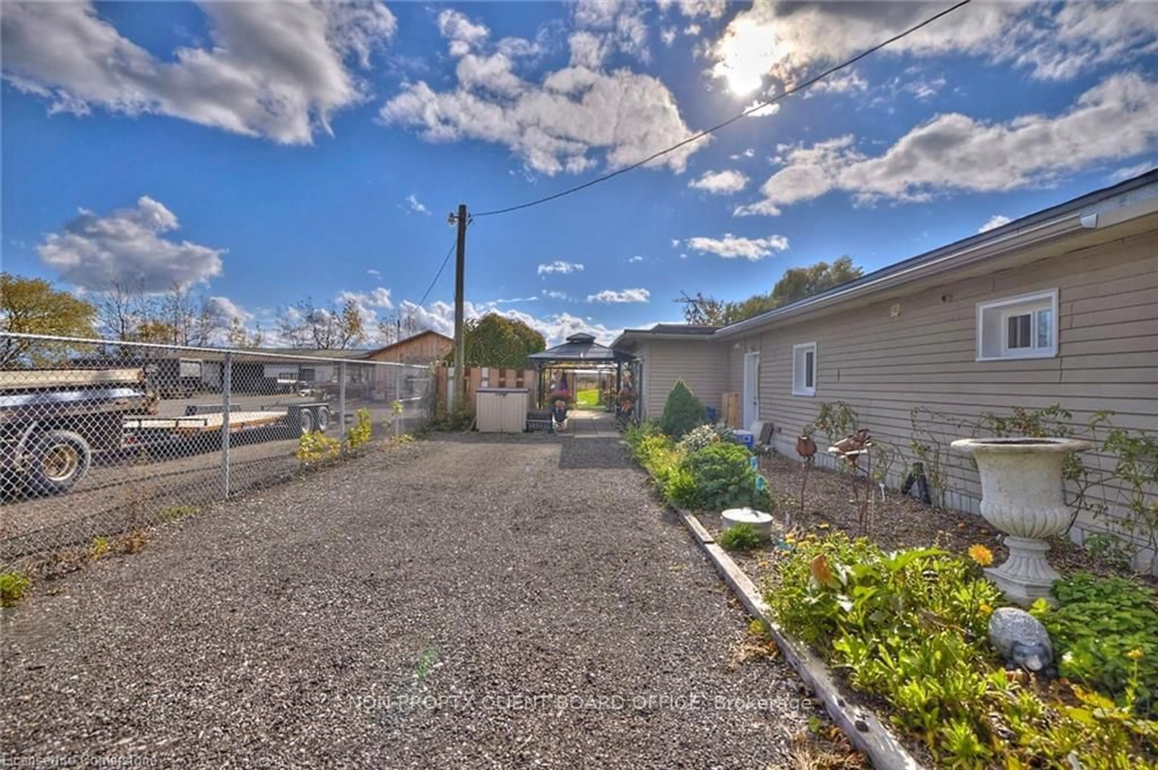 A pic from exterior of the house or condo, the fenced backyard for 11377 Highway 3, Wainfleet Ontario L3K 5V4