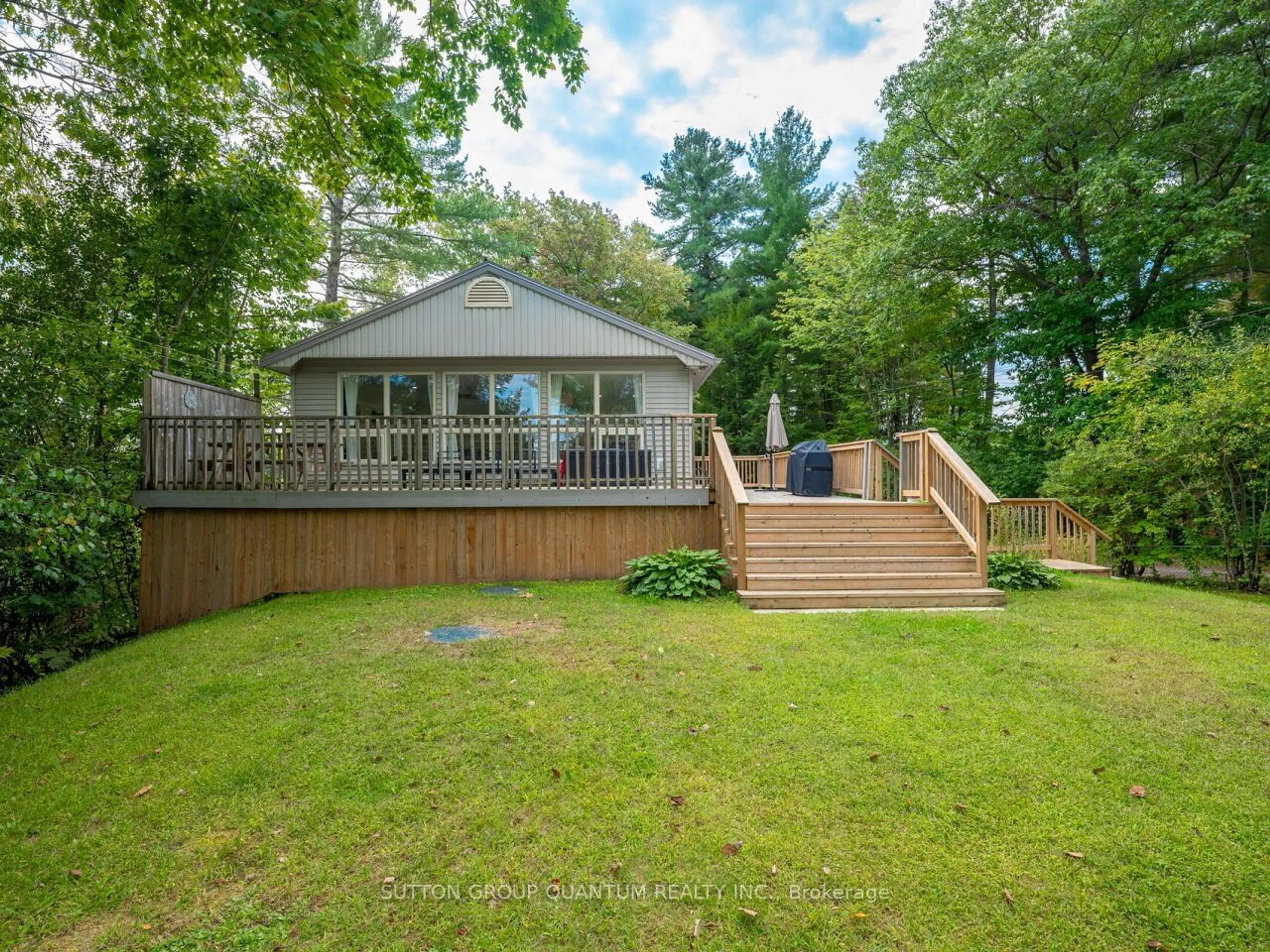 Frontside or backside of a home, the fenced backyard for 1006 Youngs Rd, Muskoka Lakes Ontario P0B 1J0