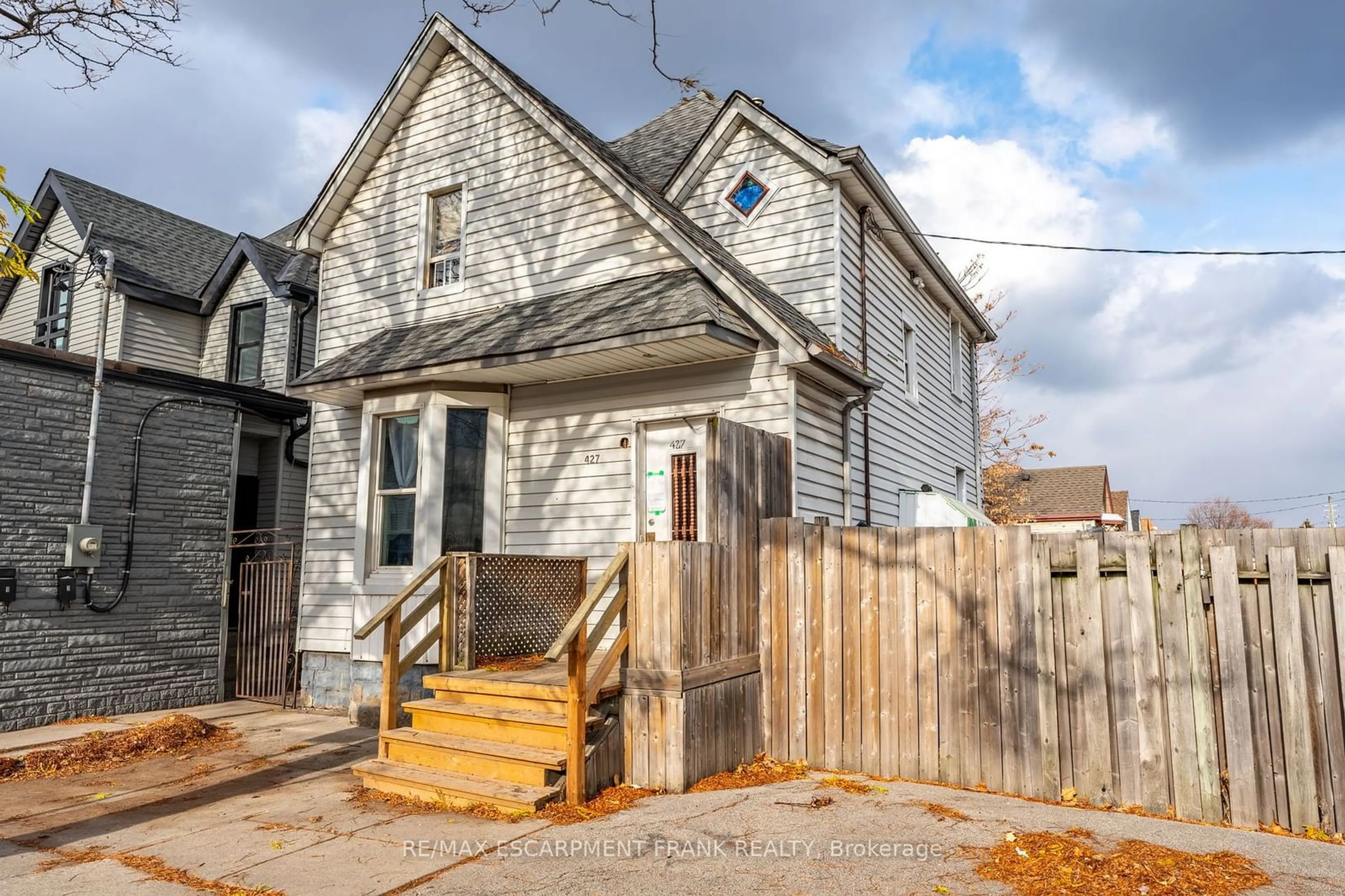 A pic from exterior of the house or condo, the fenced backyard for 427 Cannon St, Hamilton Ontario L8L 2C8