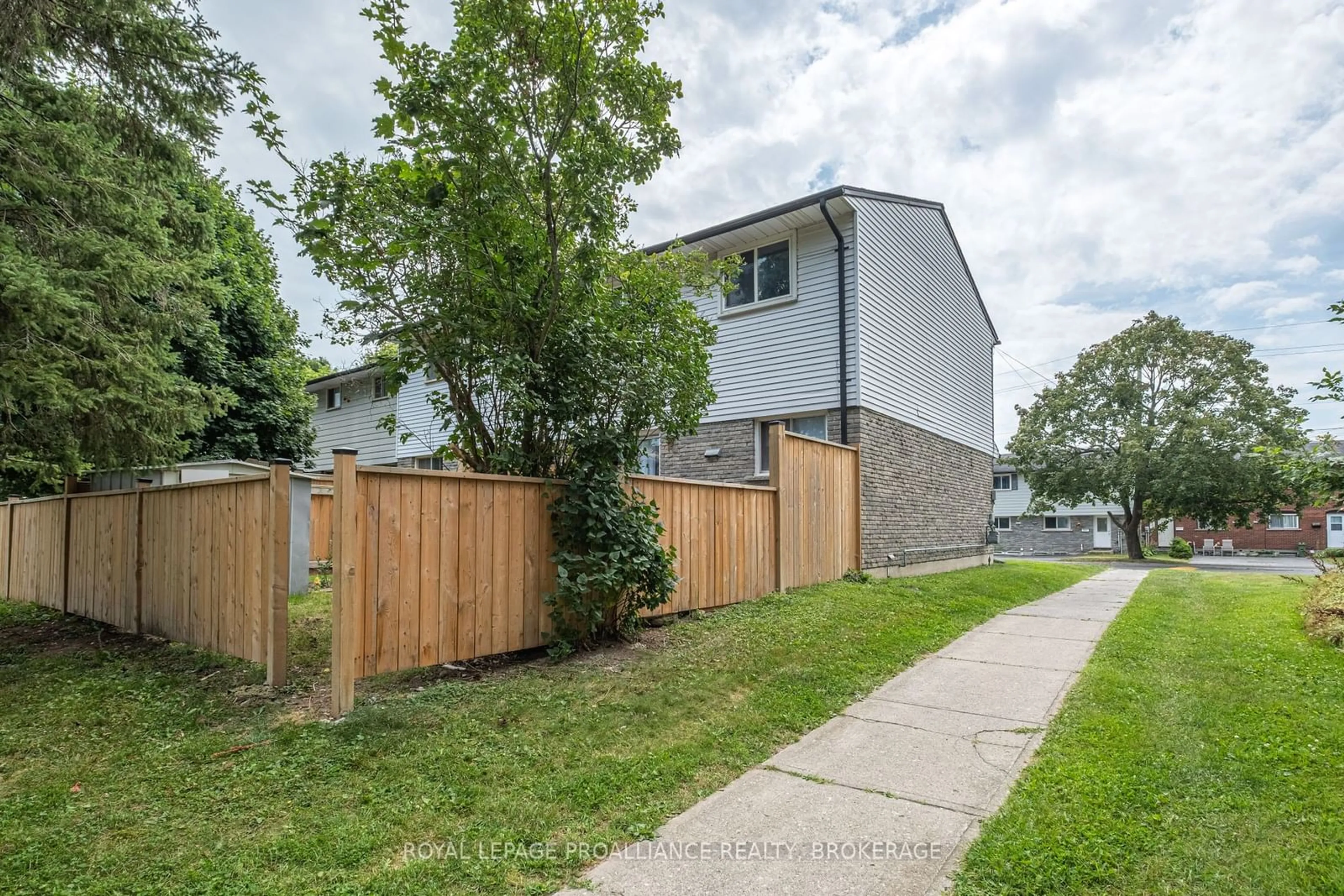 A pic from exterior of the house or condo, the fenced backyard for 930 Oakview Ave #134, Kingston Ontario K7M 6V6