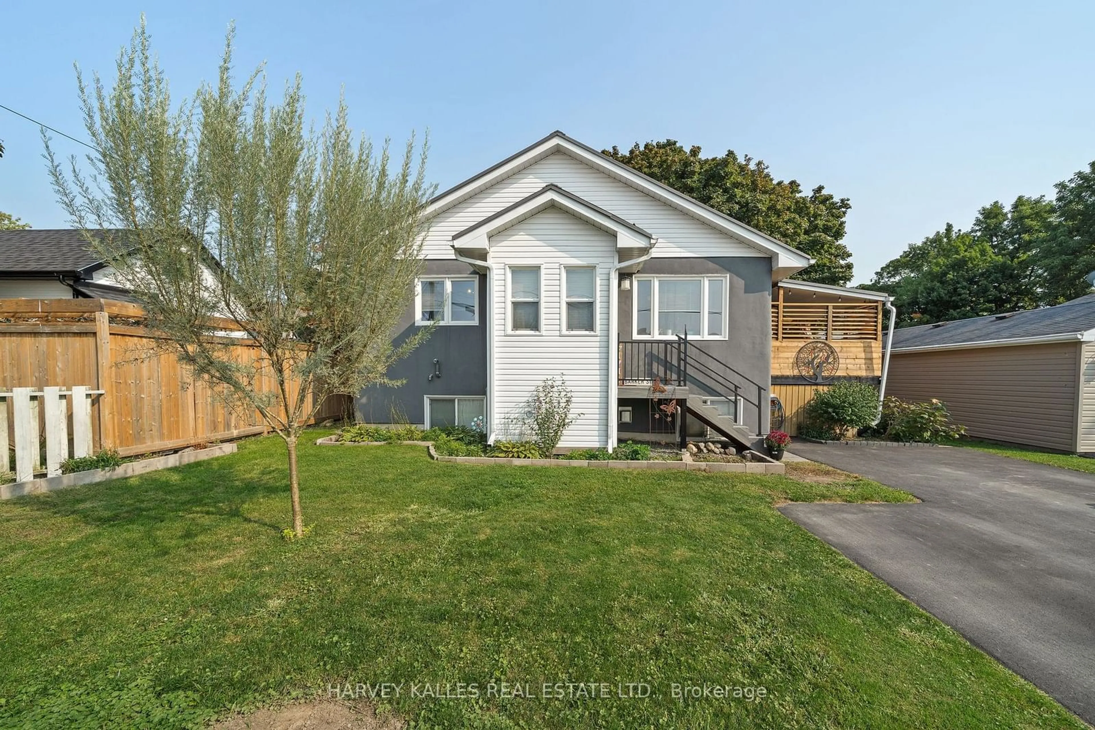 Frontside or backside of a home, the fenced backyard for 46 Barker St, Prince Edward County Ontario K0K 2T0