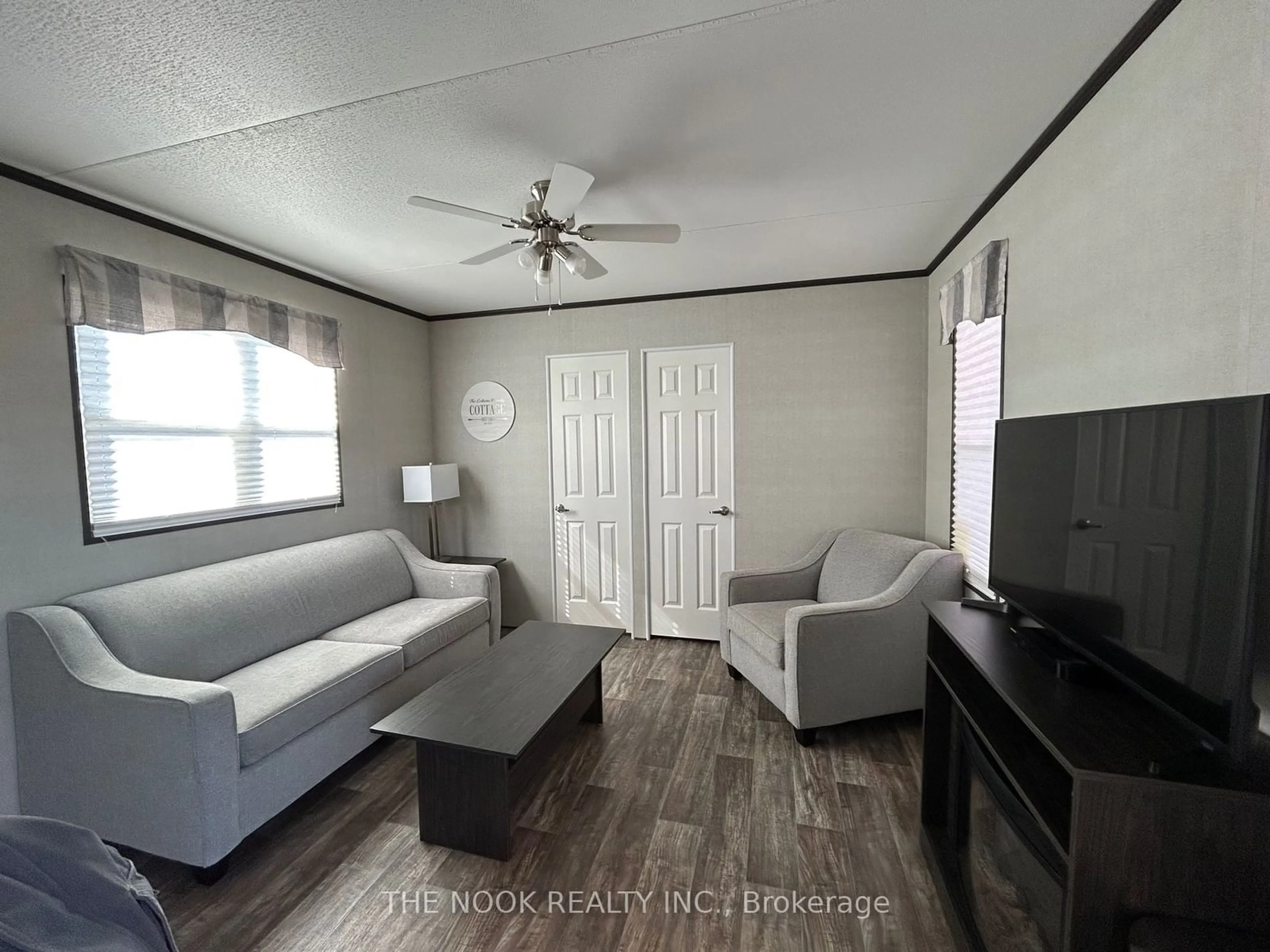 Living room with furniture, wood/laminate floor for 1235 Villiers Line #CHRY27, Otonabee-South Monaghan Ontario K0L 2G0