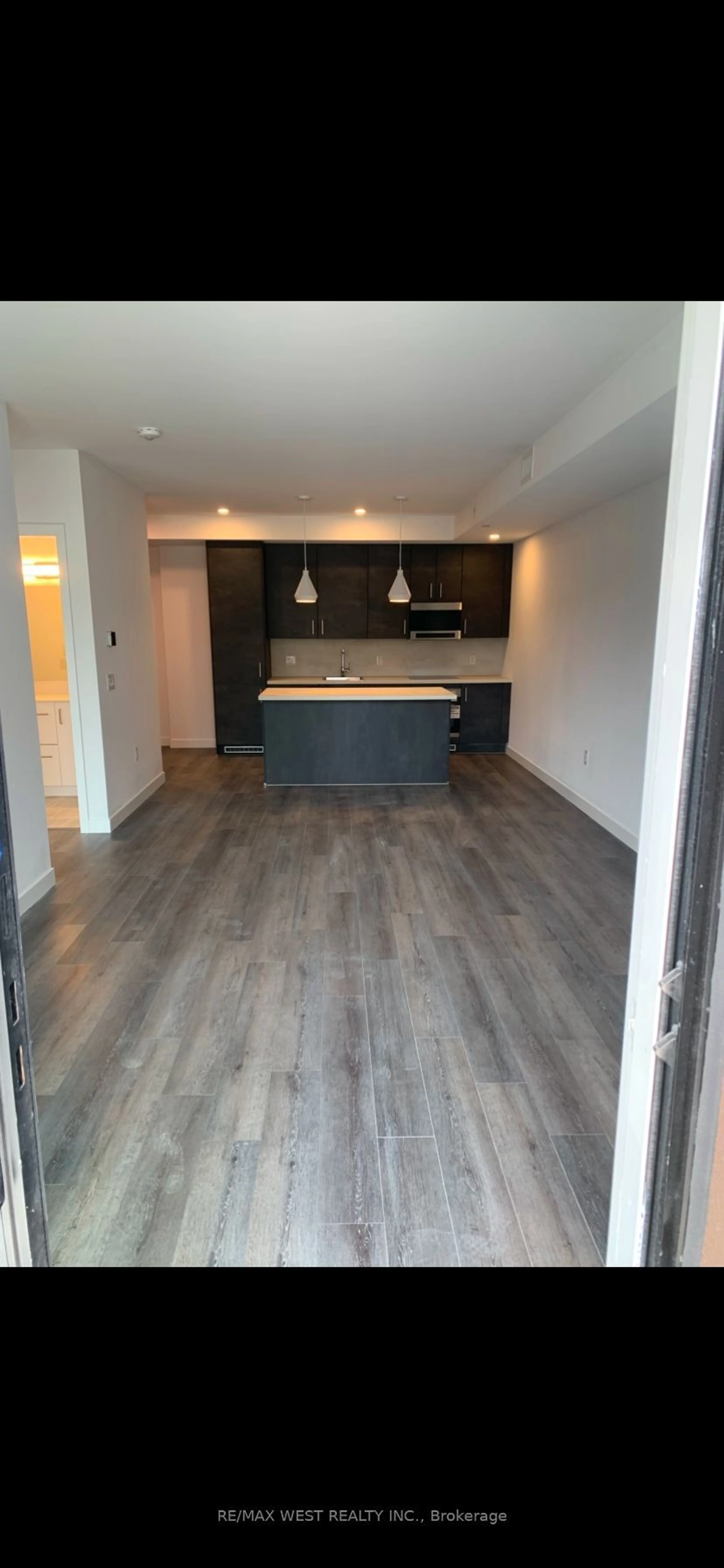 Open concept kitchen, wood/laminate floor for 7549 B Kalar Rd #211, Niagara Falls Ontario L2H 2Y6