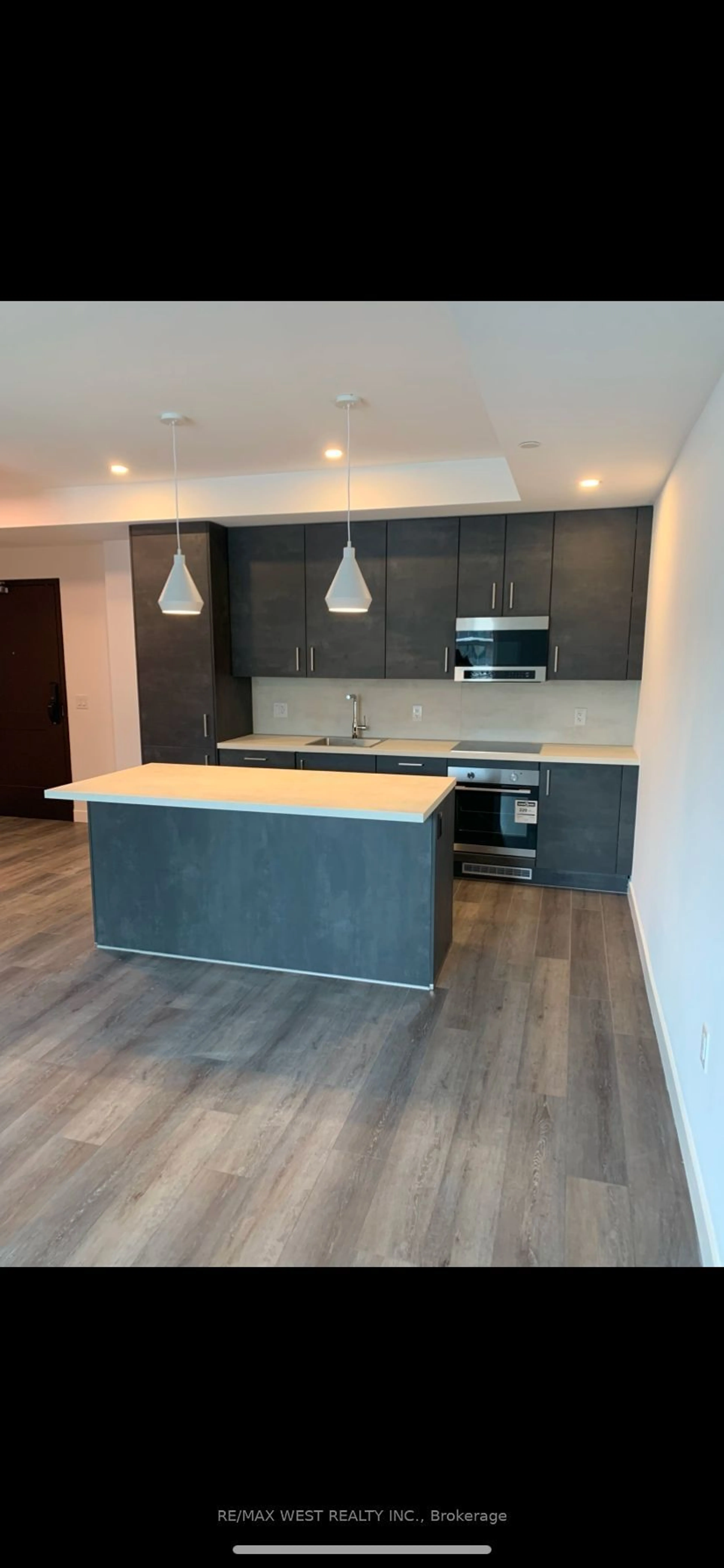 Open concept kitchen, wood/laminate floor for 7549 B Kalar Rd #211, Niagara Falls Ontario L2H 2Y6