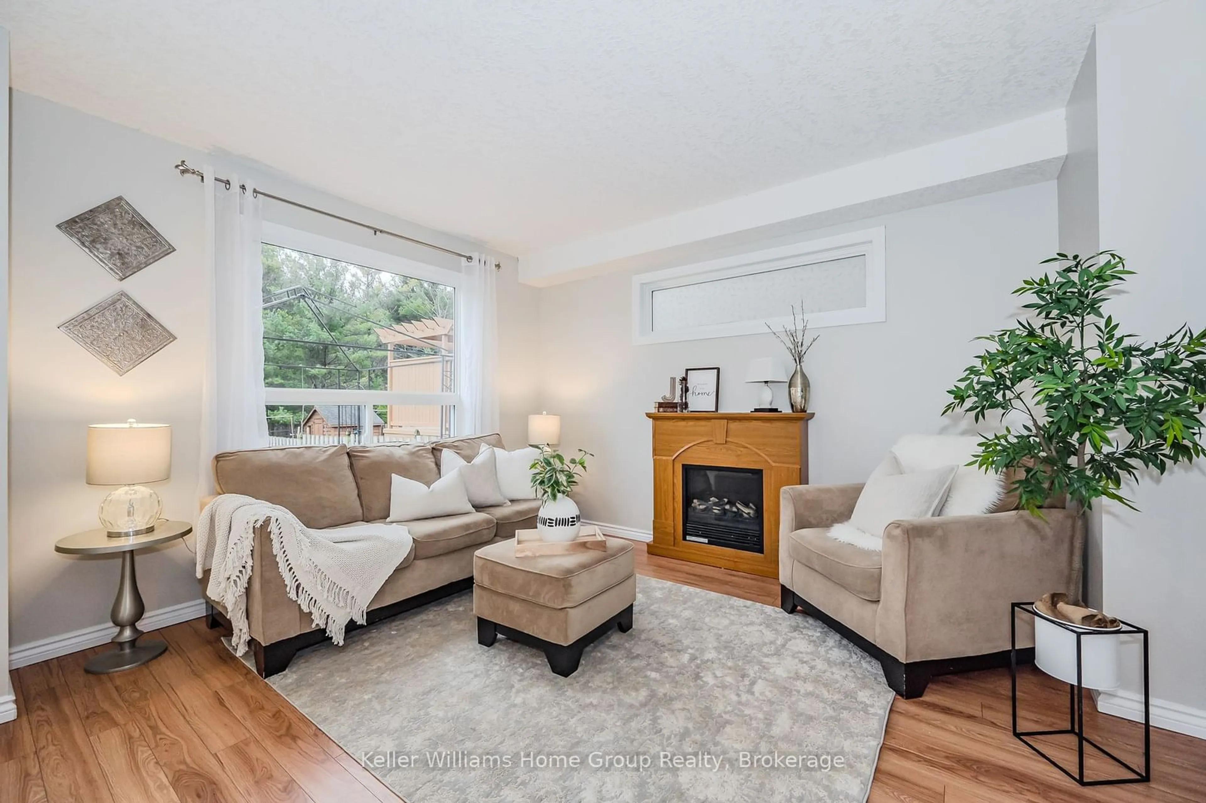 Living room with furniture, wood/laminate floor for 52 Carrington Pl, Guelph Ontario N1G 5C3