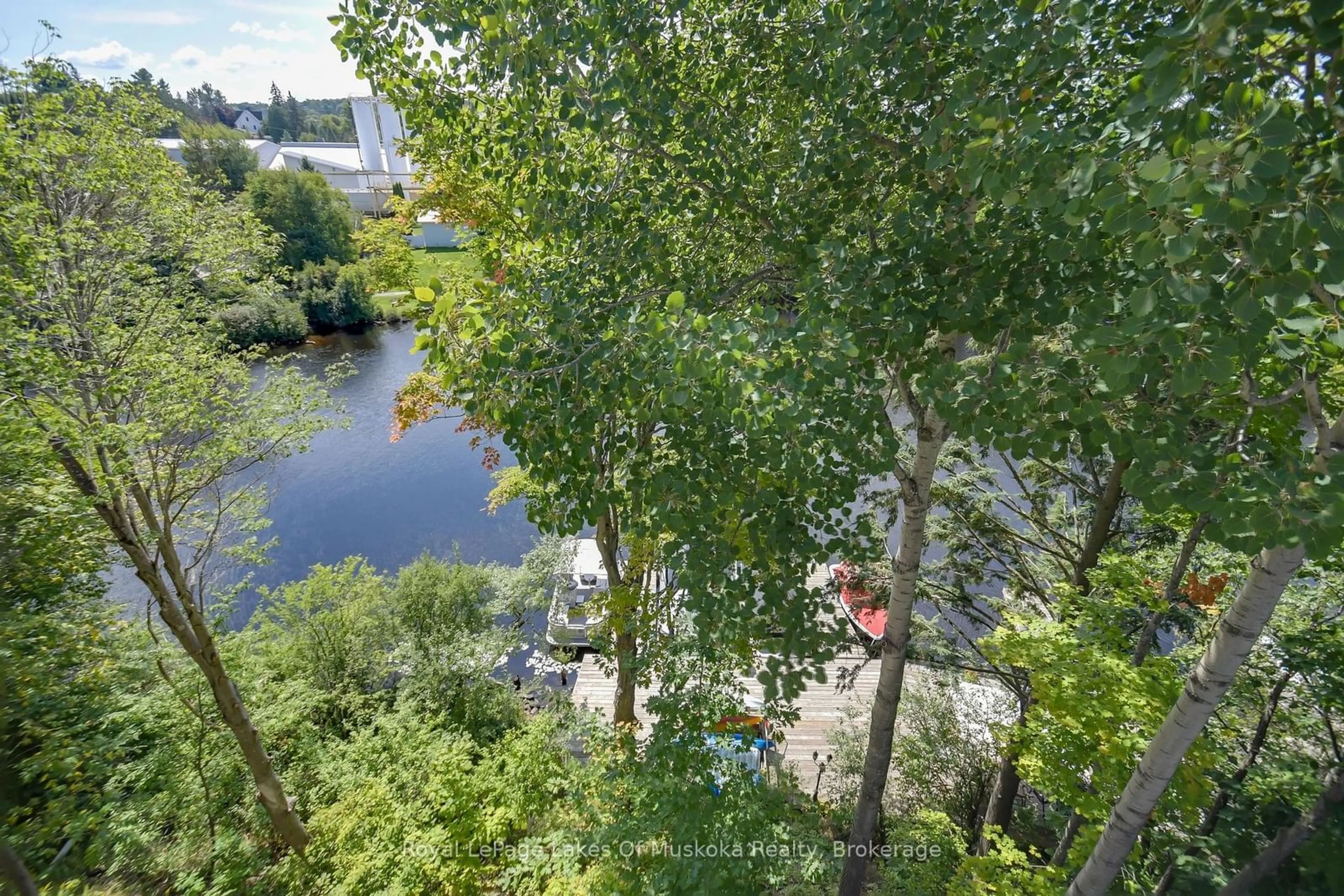 A pic from outside/outdoor area/front of a property/back of a property/a pic from drone, water/lake/river/ocean view for 31 Dairy Lane #401, Huntsville Ontario P1H 1L7