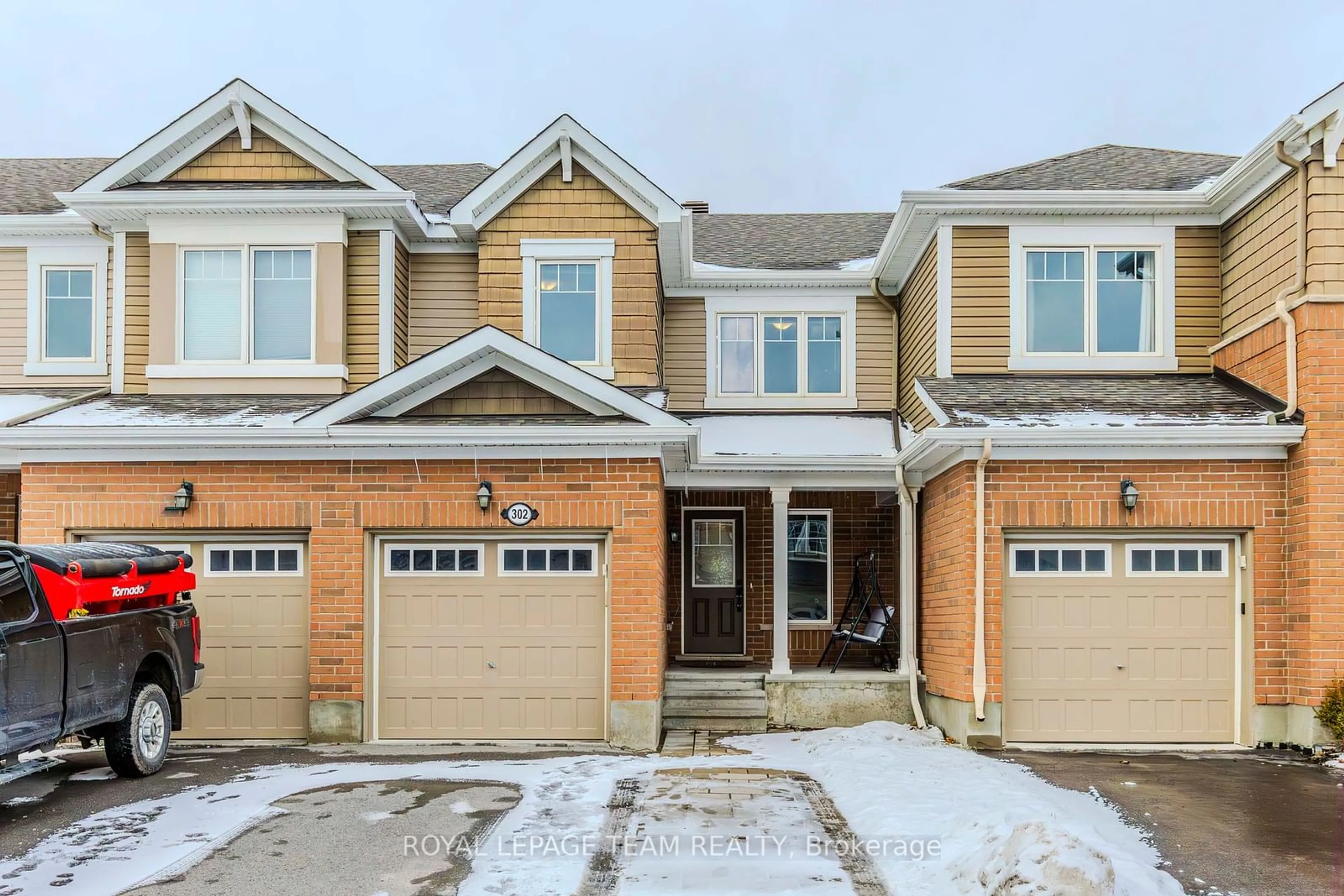 Home with brick exterior material, street for 302 Song Sparrow St, Barrhaven Ontario K2J 5W5