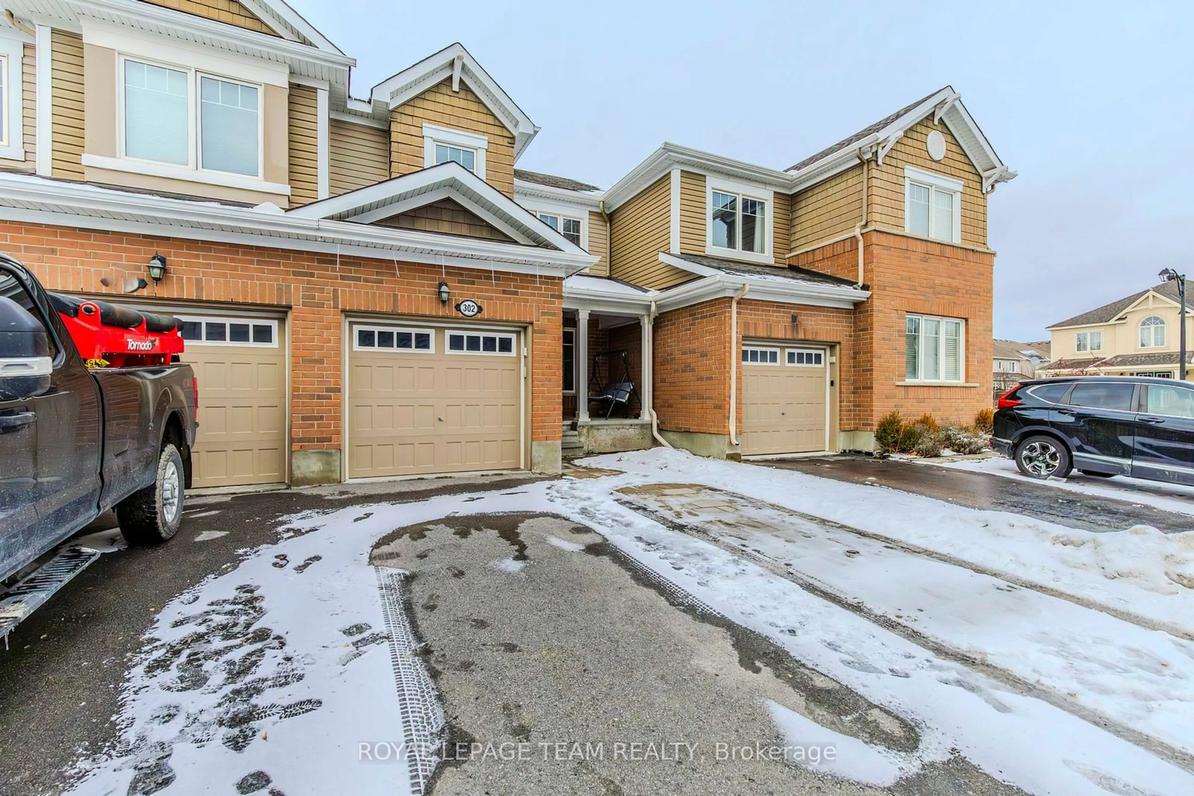 Home with brick exterior material, street for 302 Song Sparrow St, Barrhaven Ontario K2J 5W5