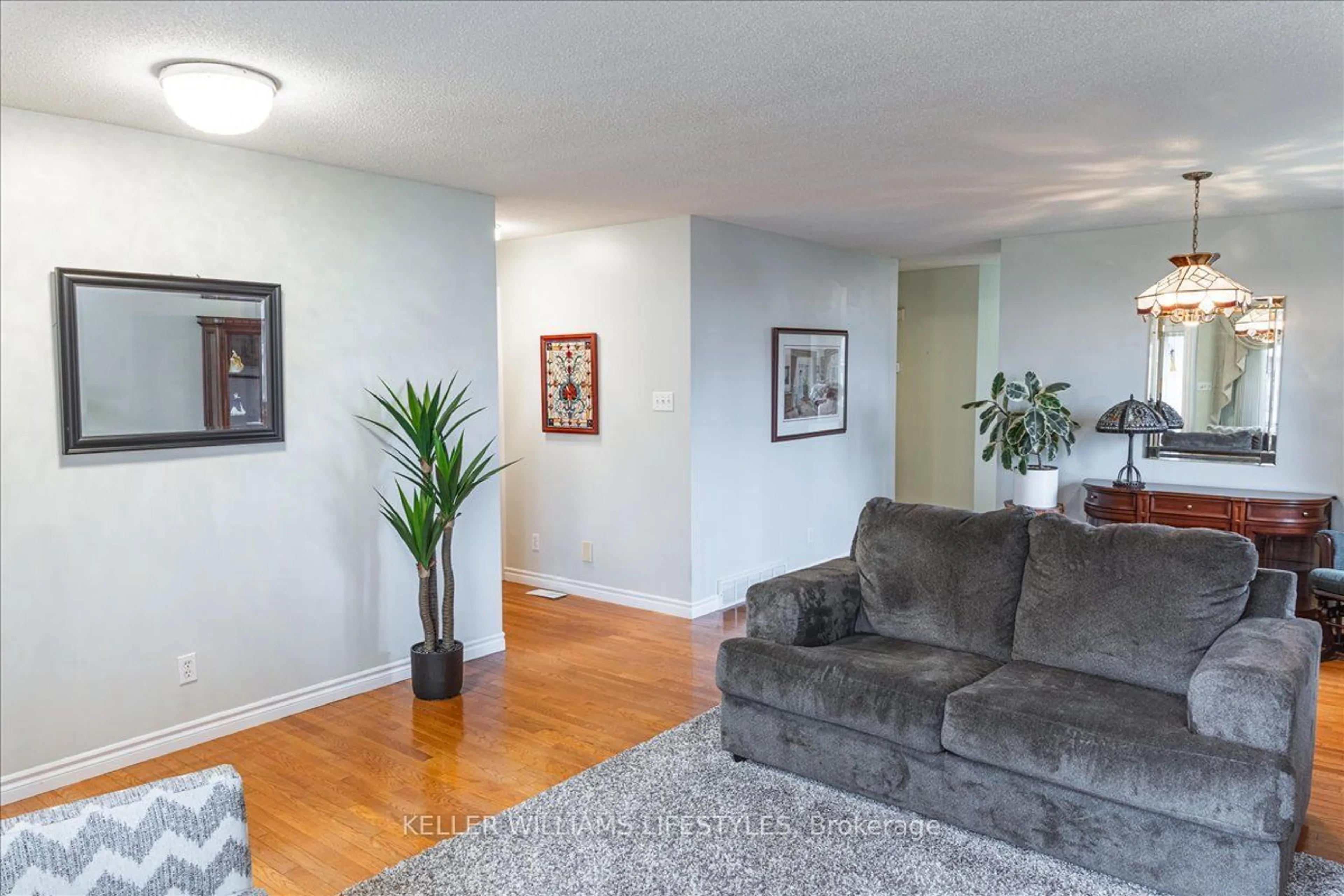 Living room with furniture, wood/laminate floor for 1241 Beaverbrook Ave #89, London Ontario N6H 5P1