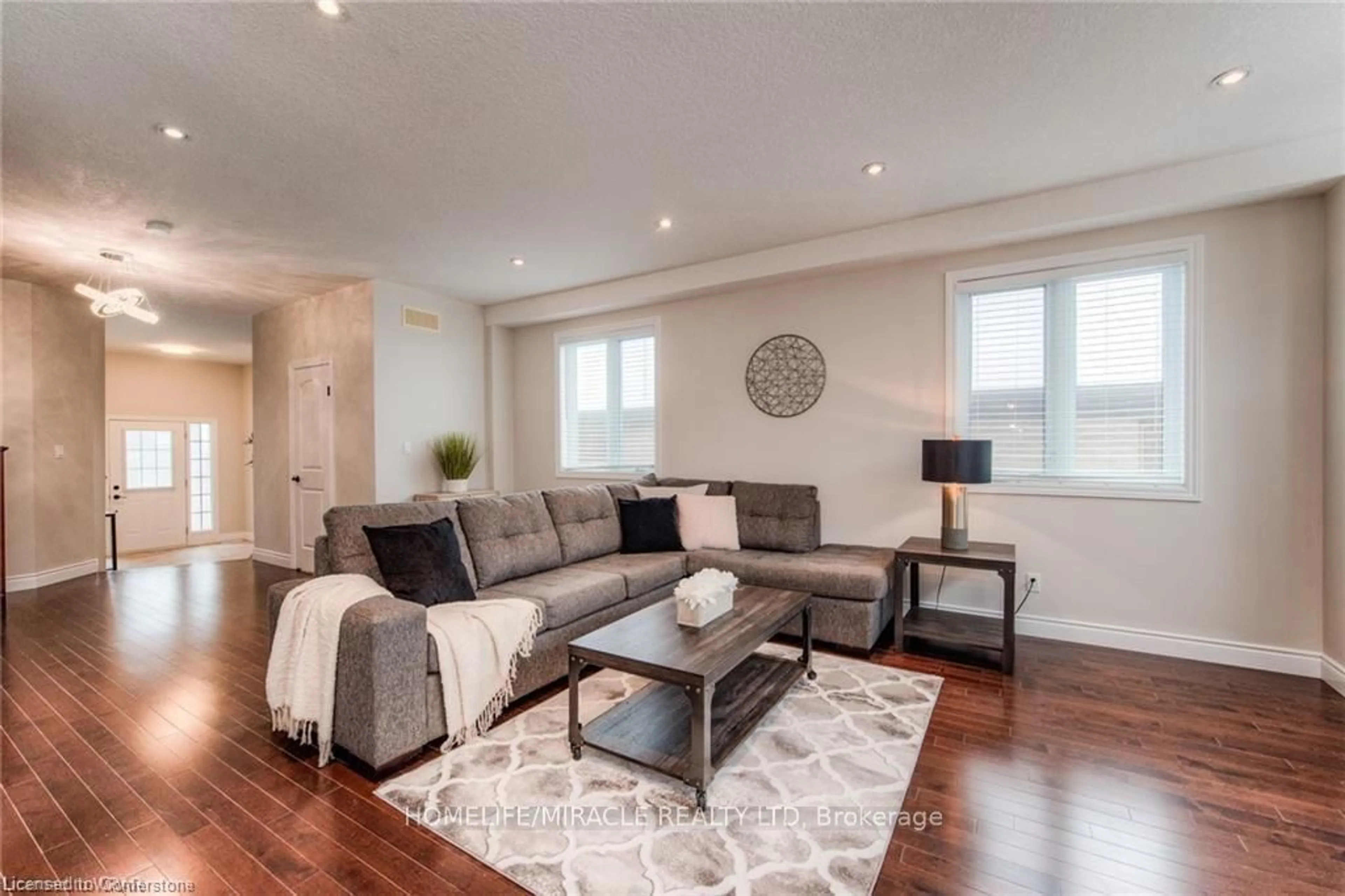 Living room with furniture, wood/laminate floor for 313 Zeller Dr, Kitchener Ontario N2A 0B2