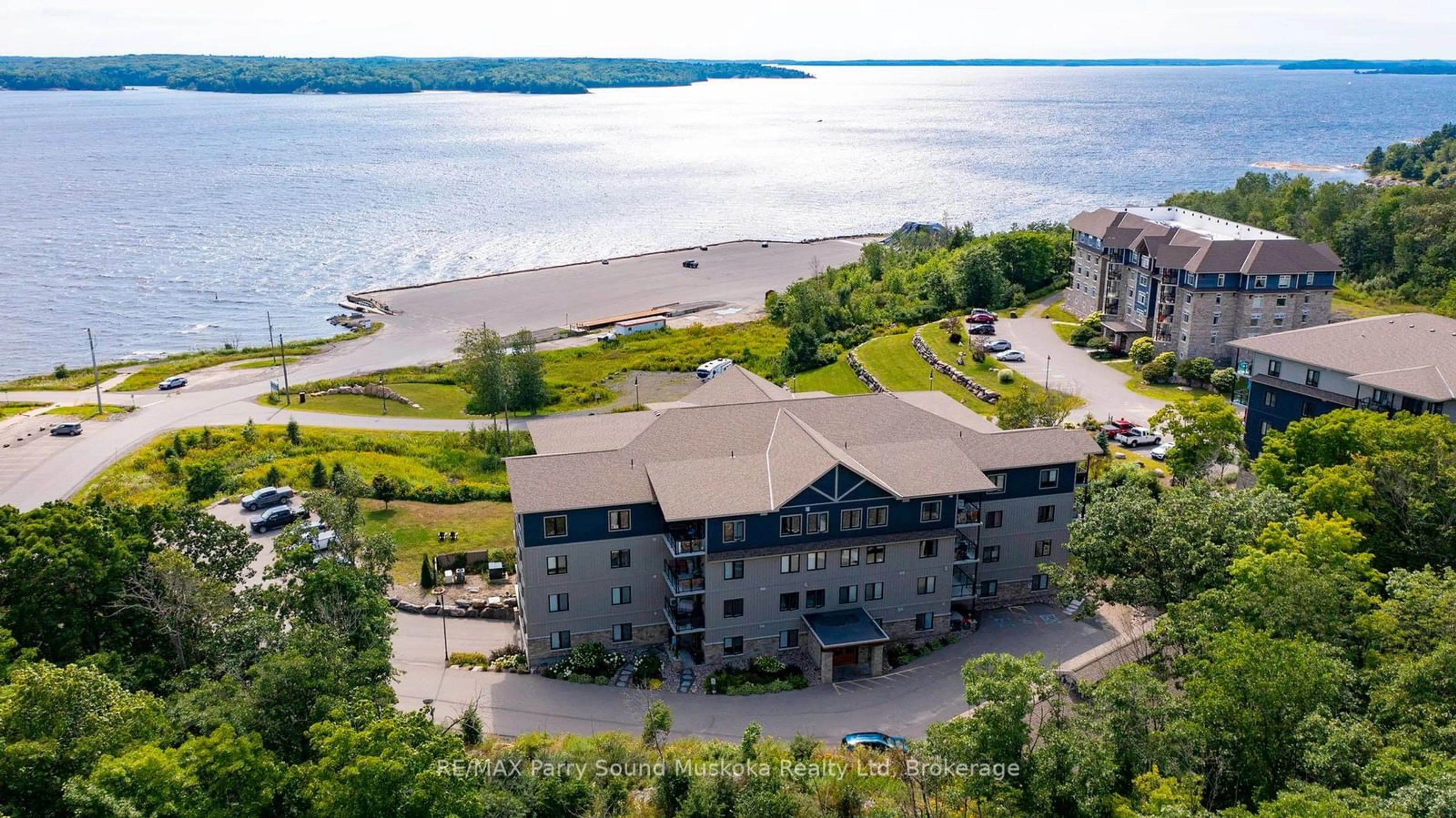 A pic from outside/outdoor area/front of a property/back of a property/a pic from drone, water/lake/river/ocean view for 11C Salt Dock Rd #201, Parry Sound Ontario P2A 3B6