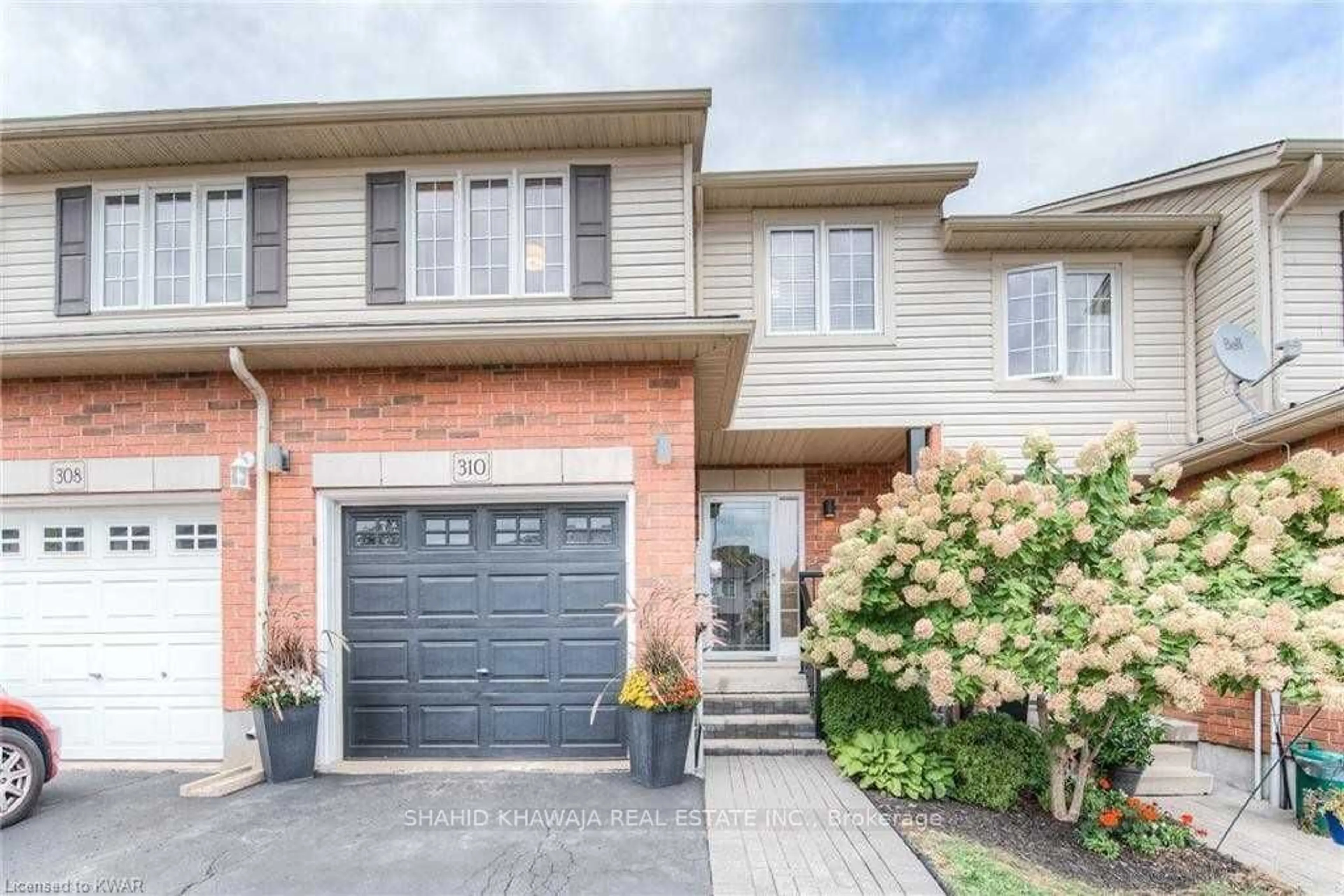 Home with brick exterior material, street for 310 Briarmeadow Dr, Kitchener Ontario N2A 4L1