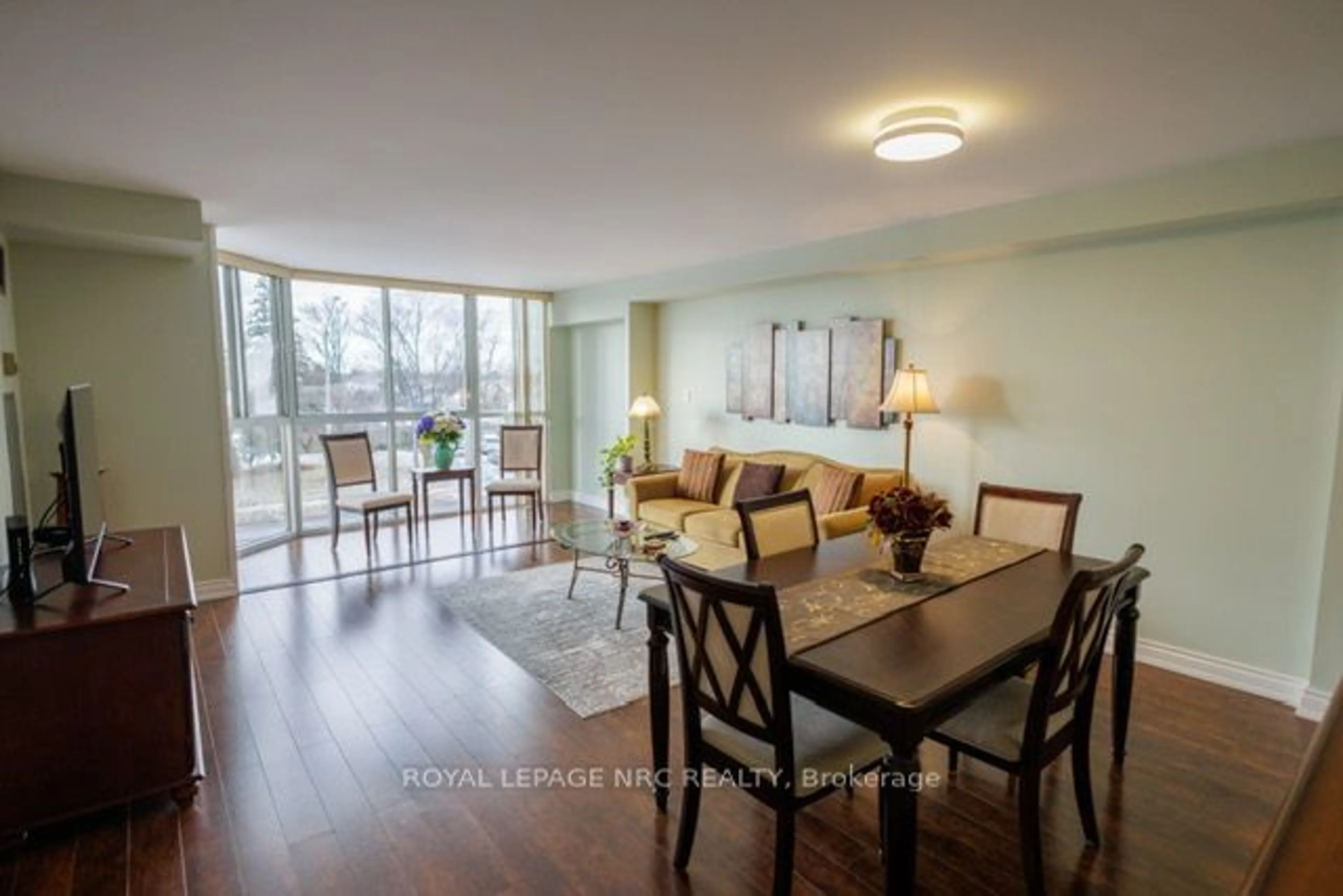 Living room with furniture, wood/laminate floor for 162 Martindale Rd #301, St. Catharines Ontario L2S 3S4