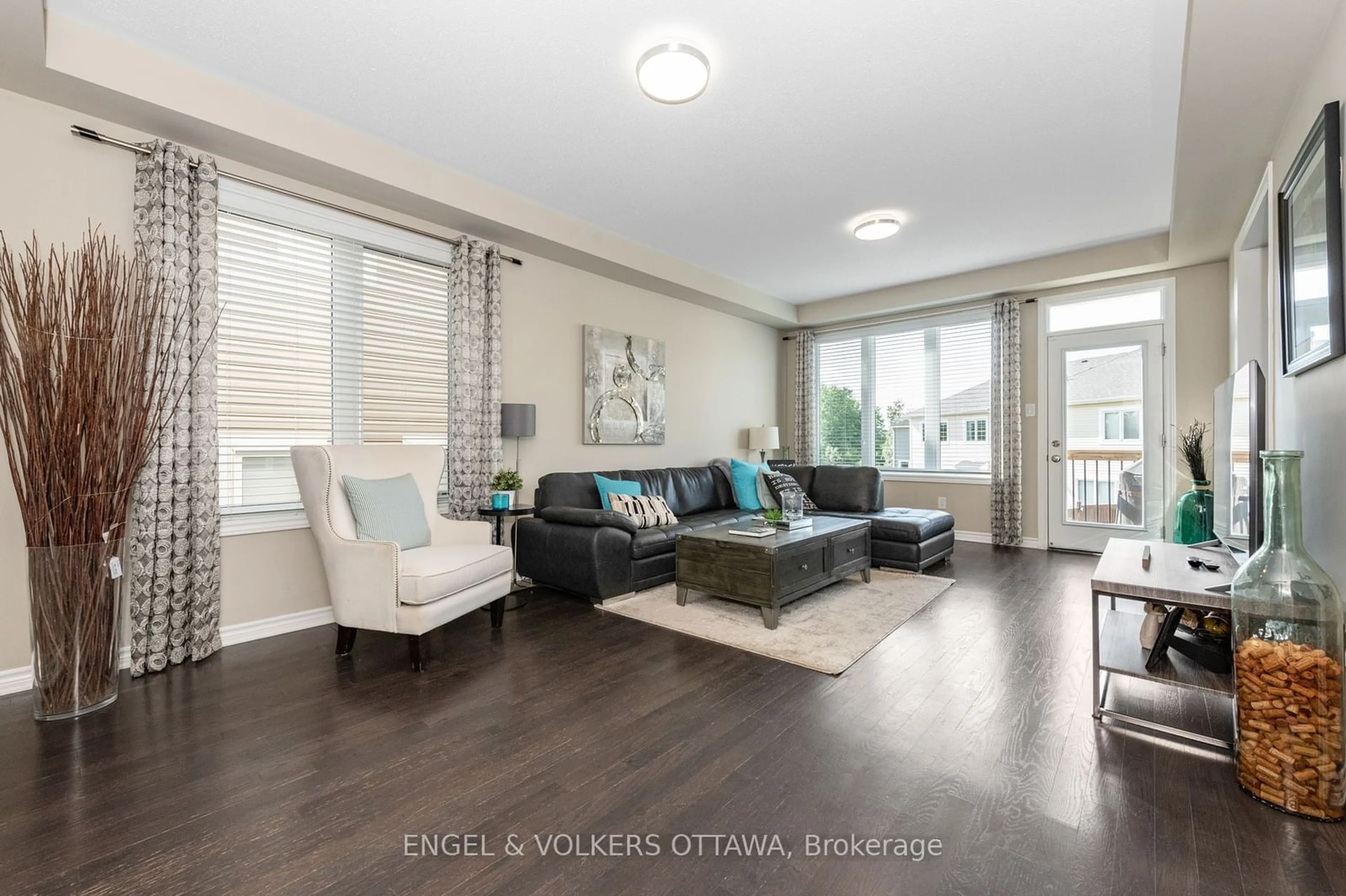 Living room with furniture, wood/laminate floor for 654 Dundonald Dr, Barrhaven Ontario K2J 6C6