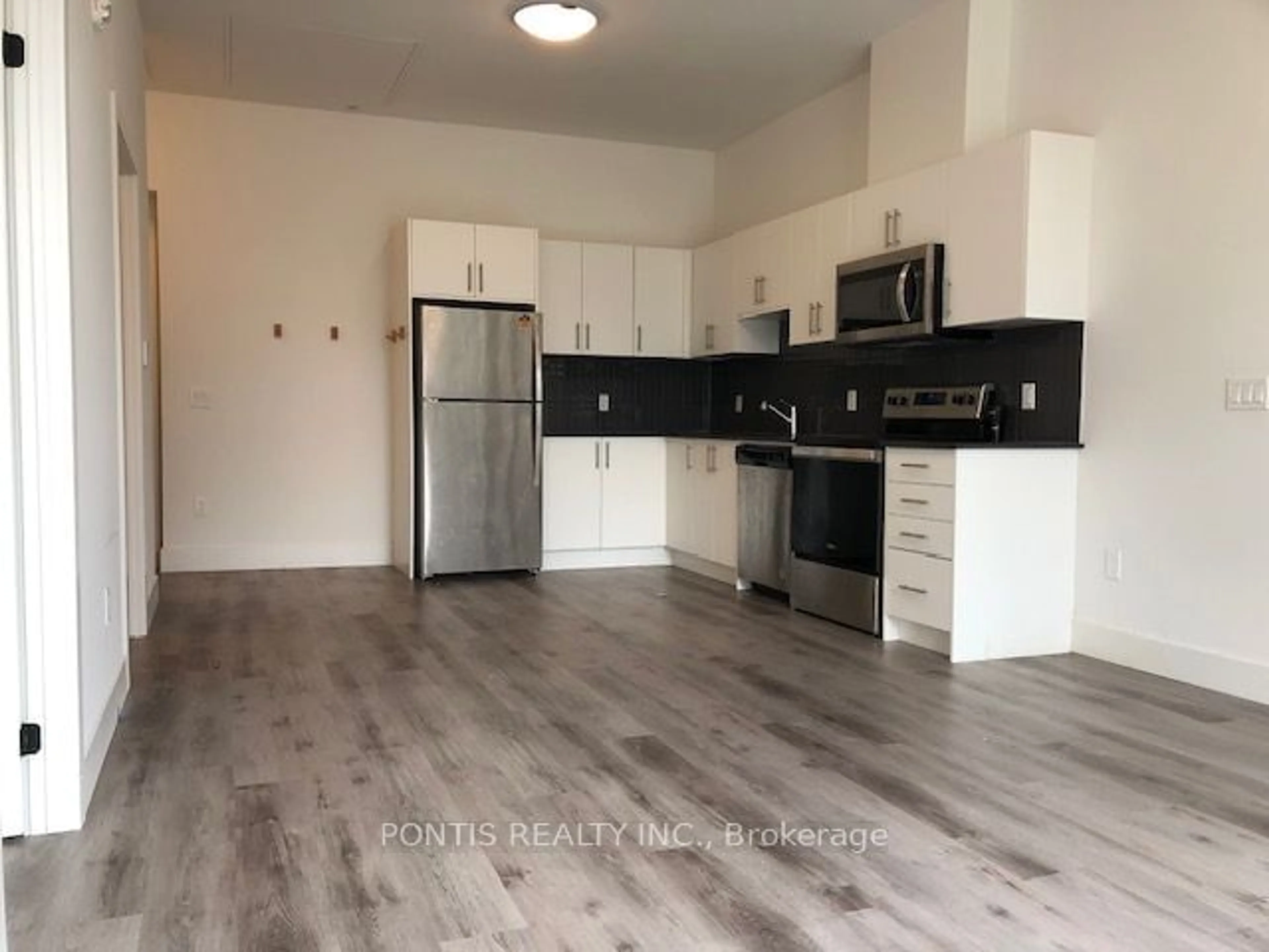 Open concept kitchen, wood/laminate floor for 103 Roger St #104, Waterloo Ontario N2J 0G2