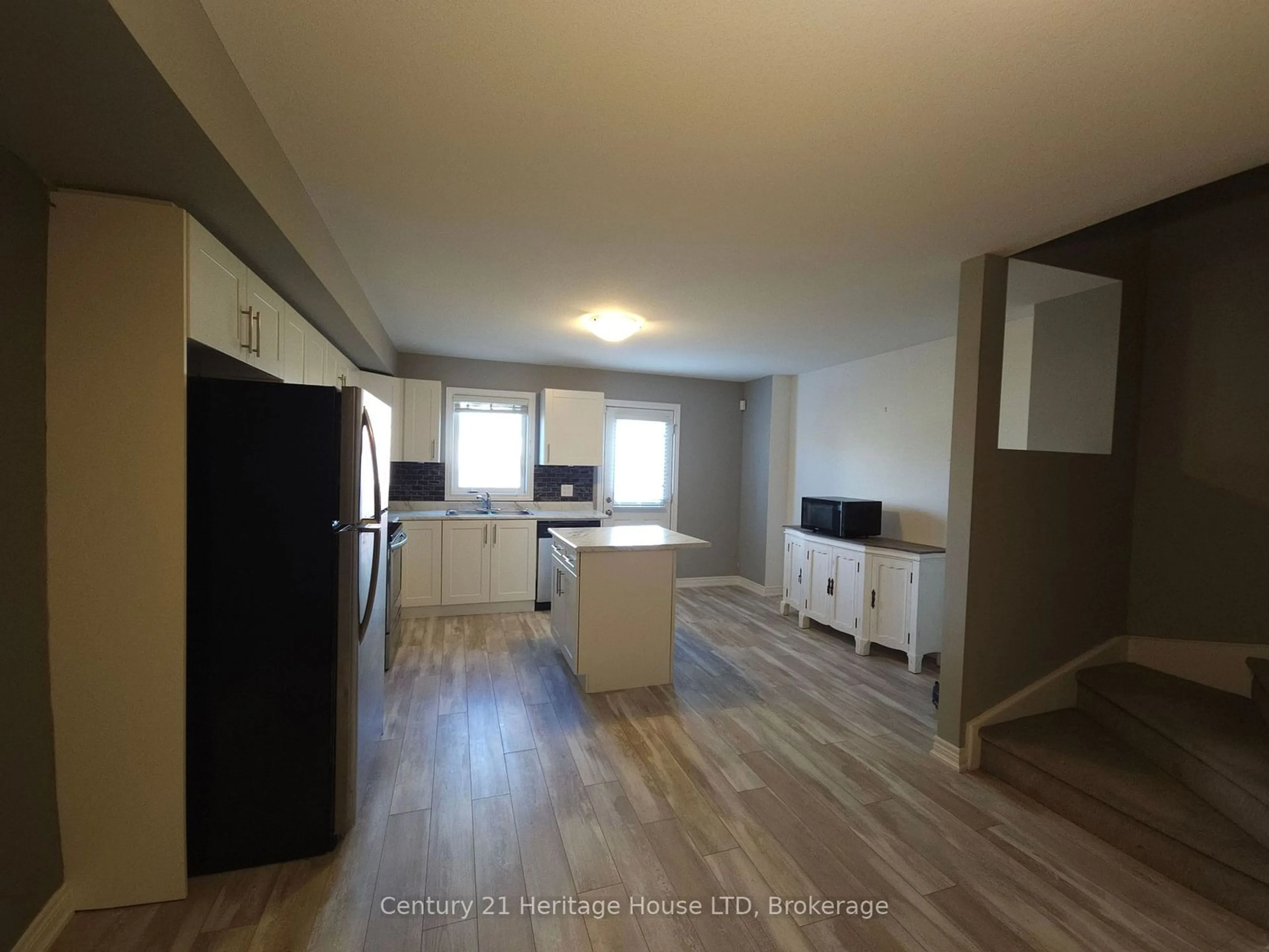 Open concept kitchen, wood/laminate floor for 7768 Ascot Circ #7, Niagara Falls Ontario L2H 3P9