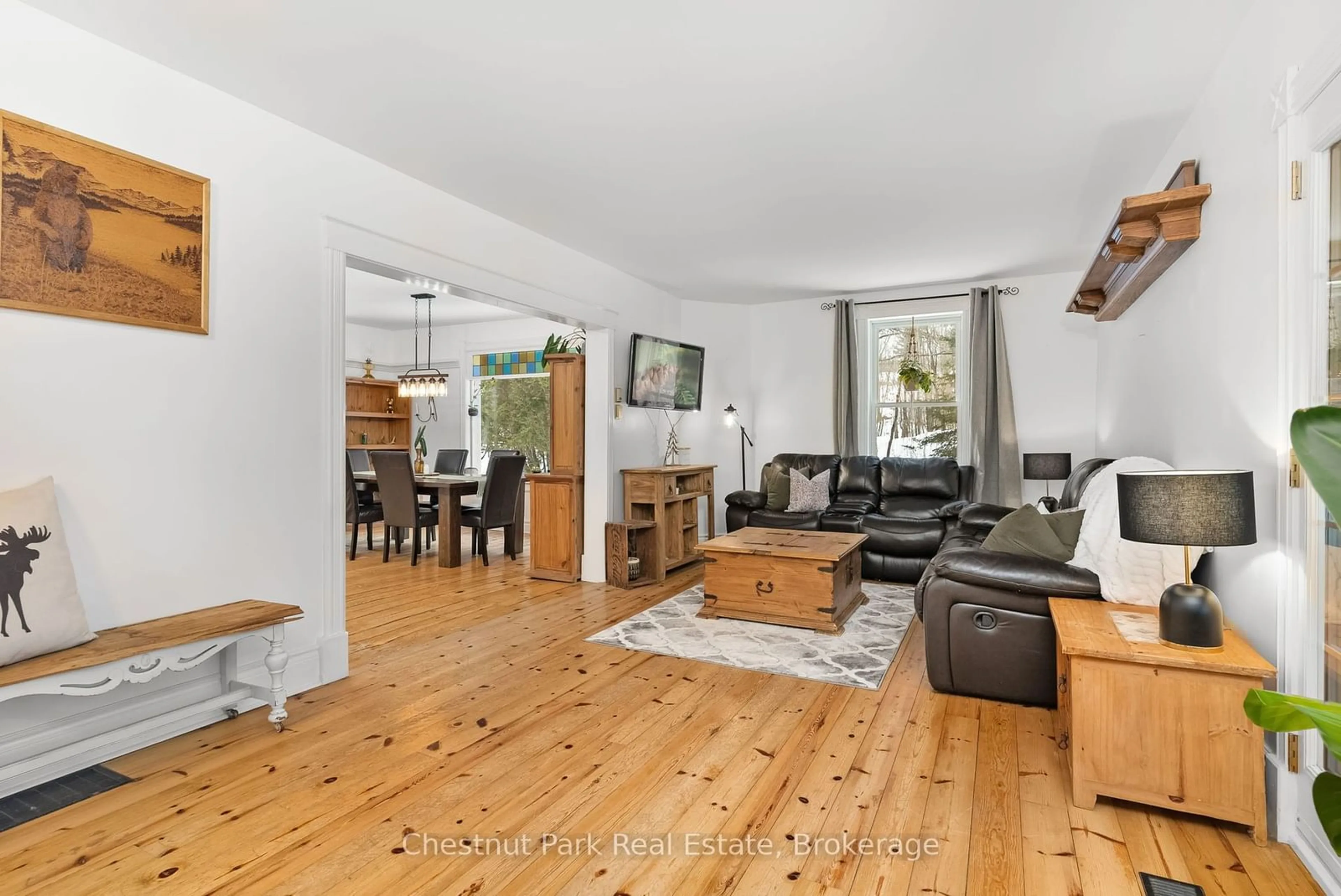 Living room with furniture, wood/laminate floor for 1236 Butter & Egg Rd, Muskoka Lakes Ontario P1L 1X4