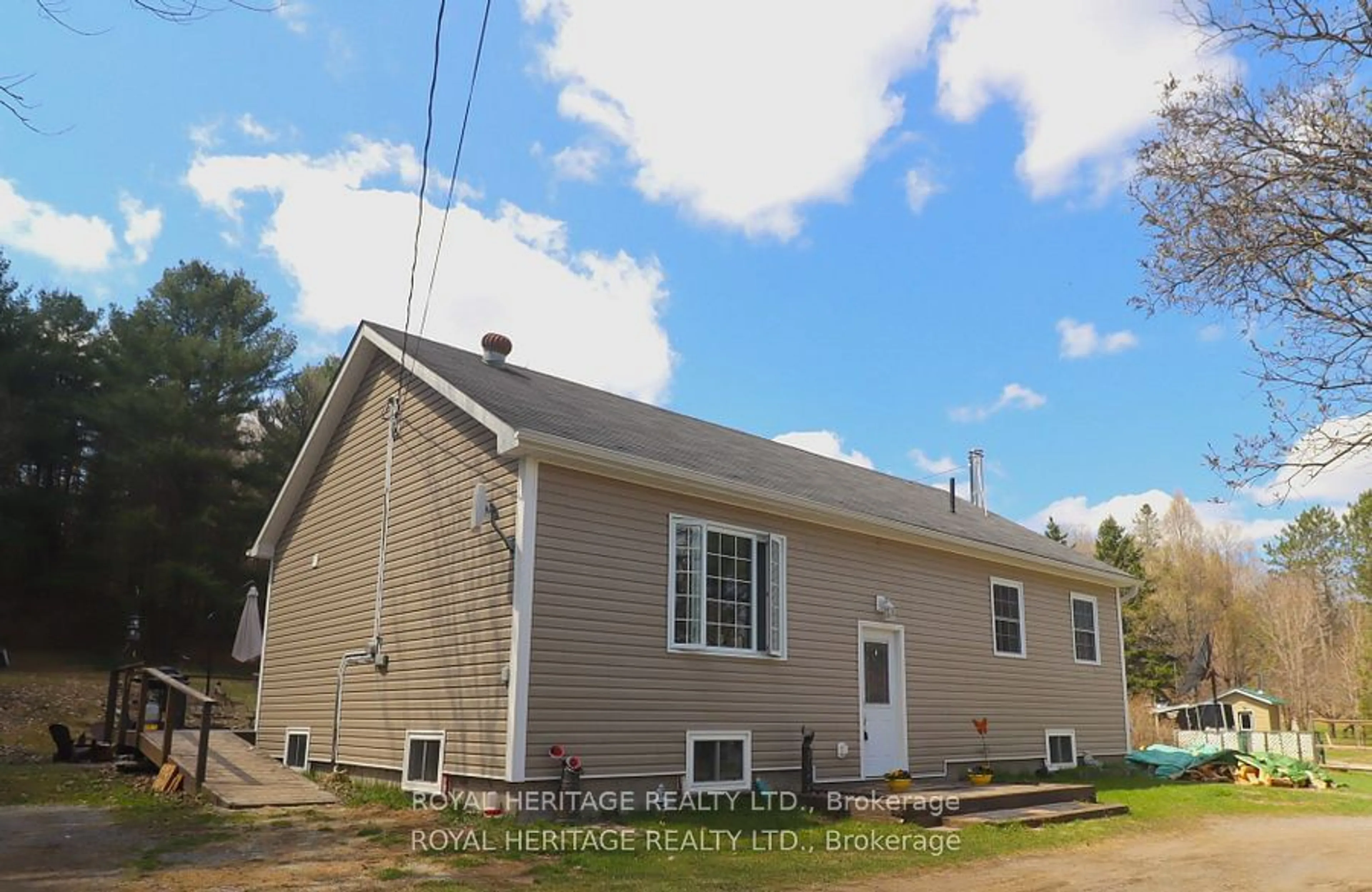 Home with vinyl exterior material, street for 1025 Dewey St, Highlands East Ontario K0M 1R0