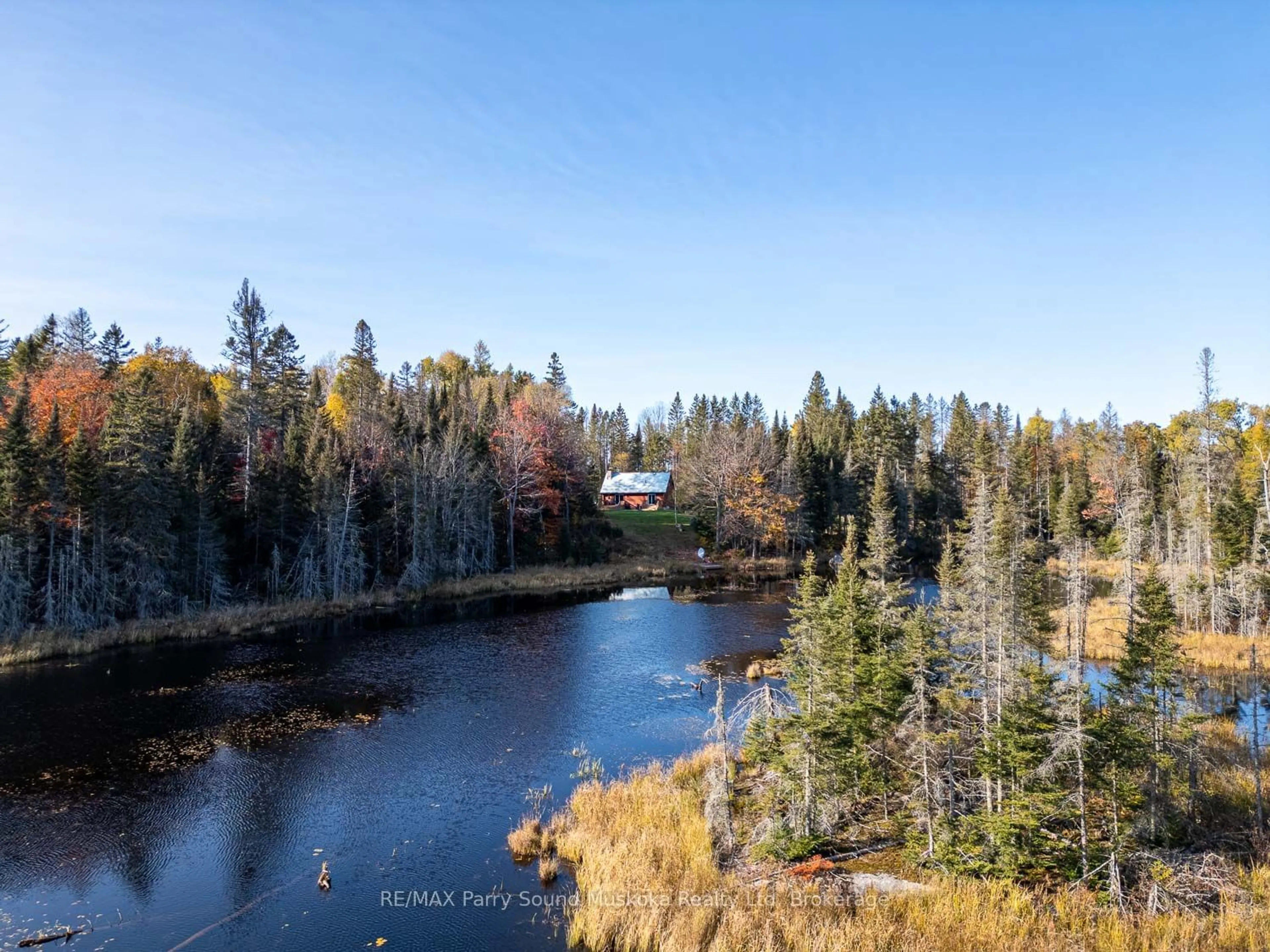 A pic from outside/outdoor area/front of a property/back of a property/a pic from drone, water/lake/river/ocean view for 879 South Horn Lake Rd, Armour Ontario P0A 1C0