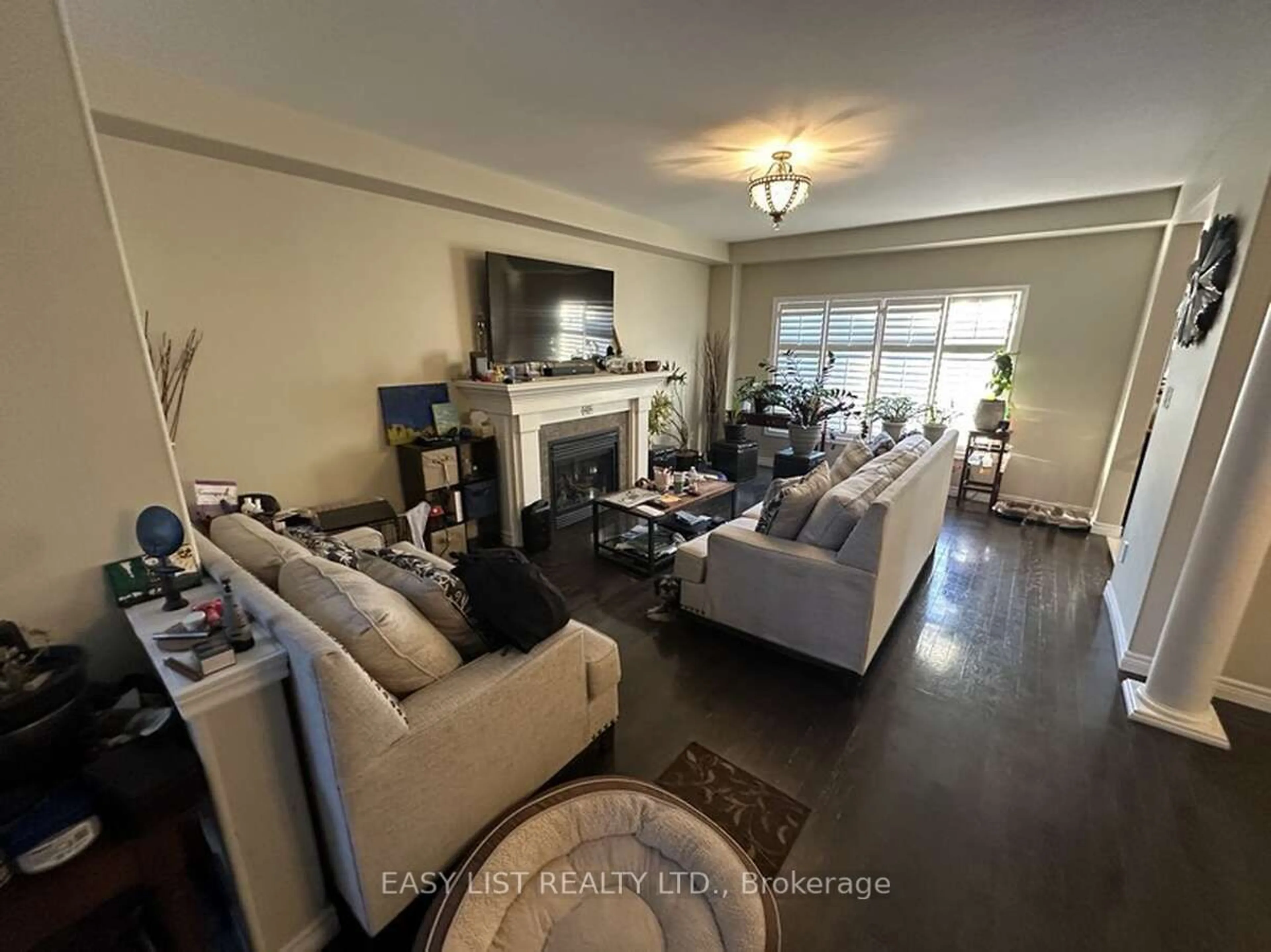 Living room with furniture, wood/laminate floor for 80 Great Oak Tr, Hamilton Ontario L0R 1C0