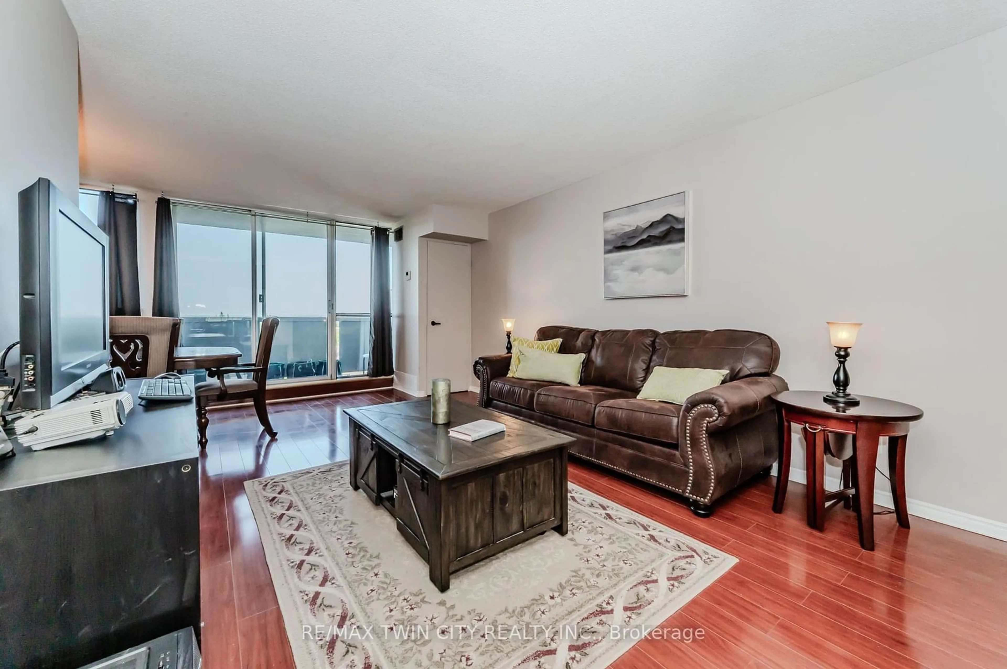 Living room with furniture, wood/laminate floor for 375 King St #707, Waterloo Ontario N2J 4L6