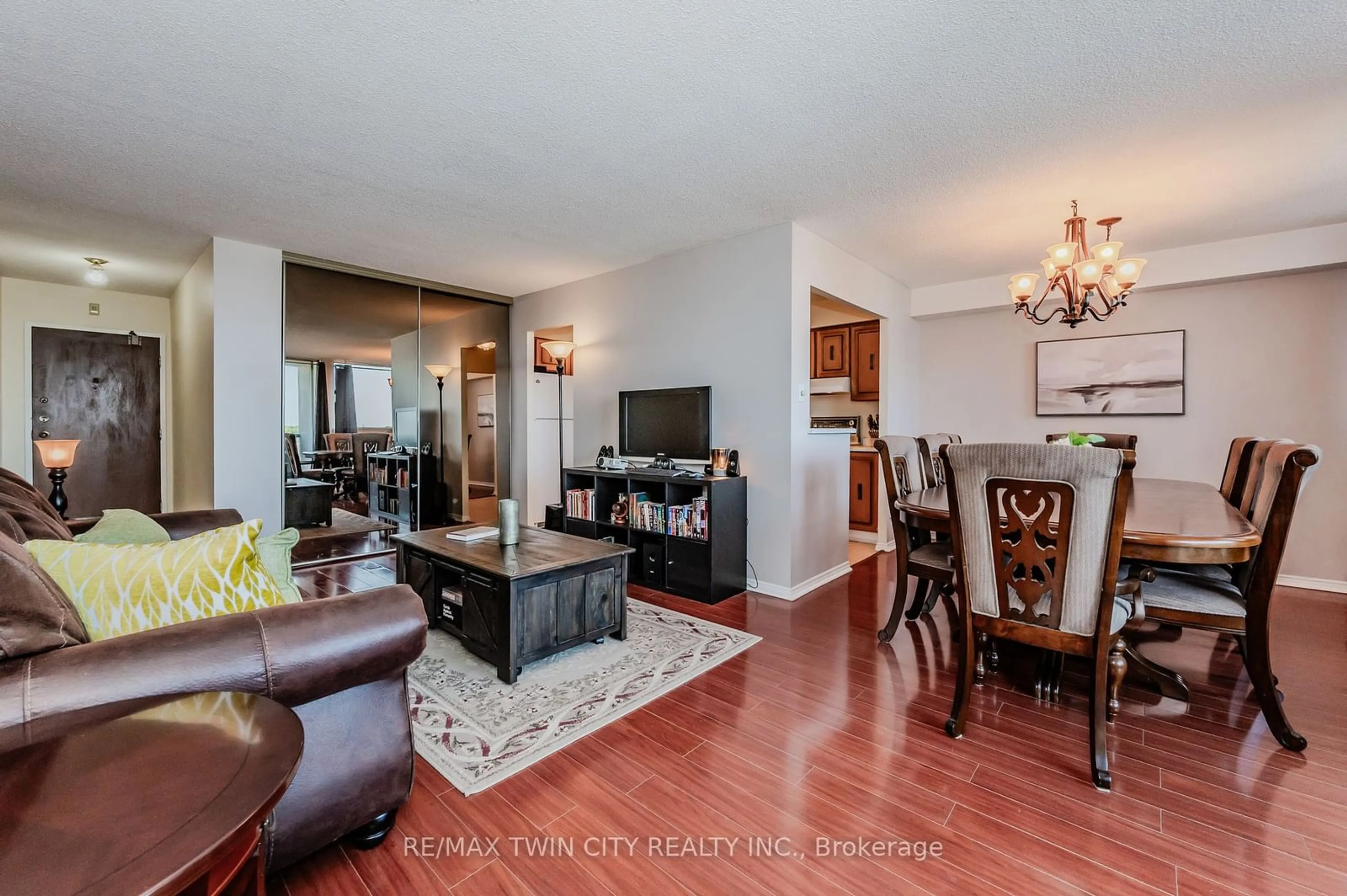 Living room with furniture, wood/laminate floor for 375 King St #707, Waterloo Ontario N2J 4L6