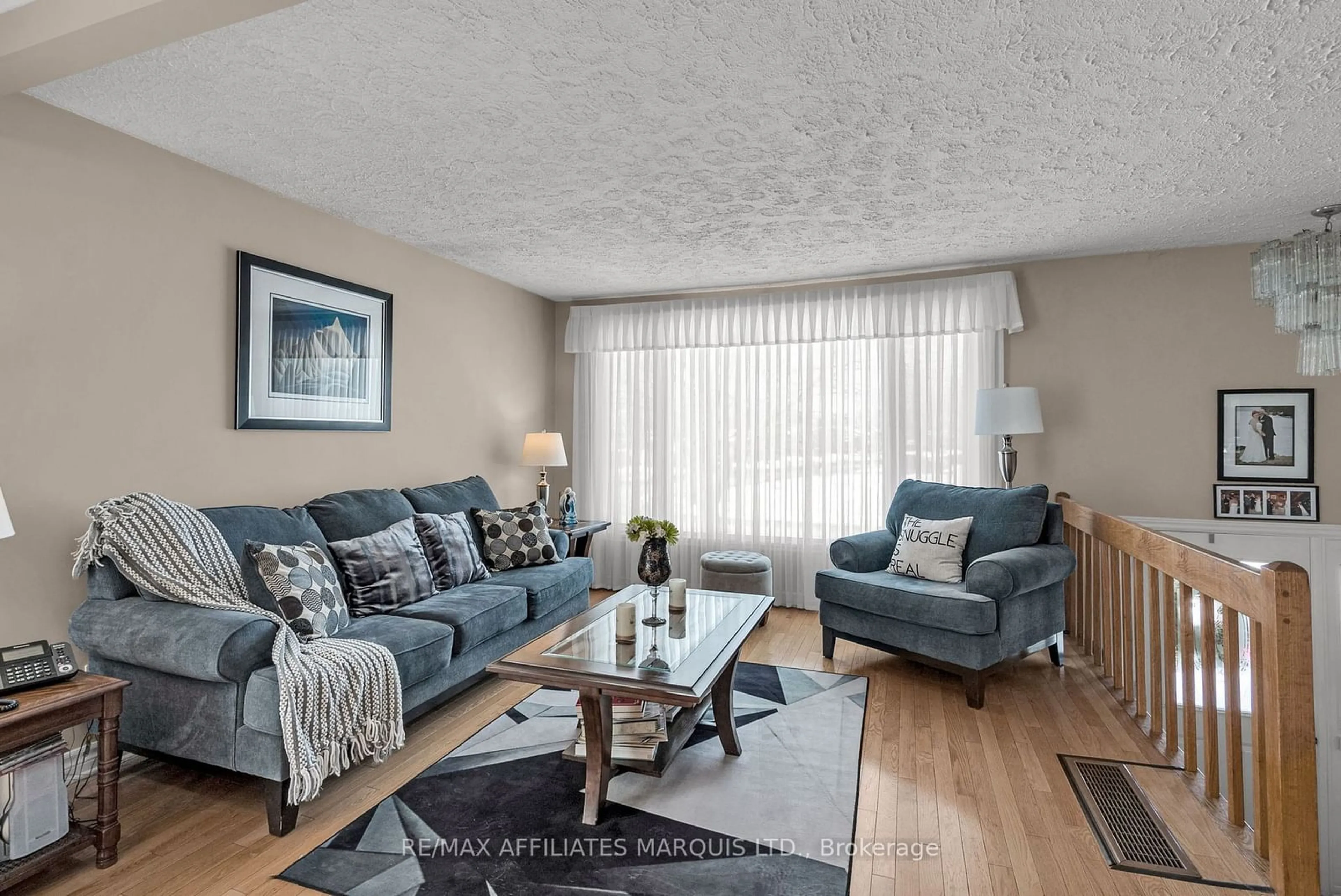 Living room with furniture, wood/laminate floor for 755 Montcalm Crt, Cornwall Ontario K6H 6C2