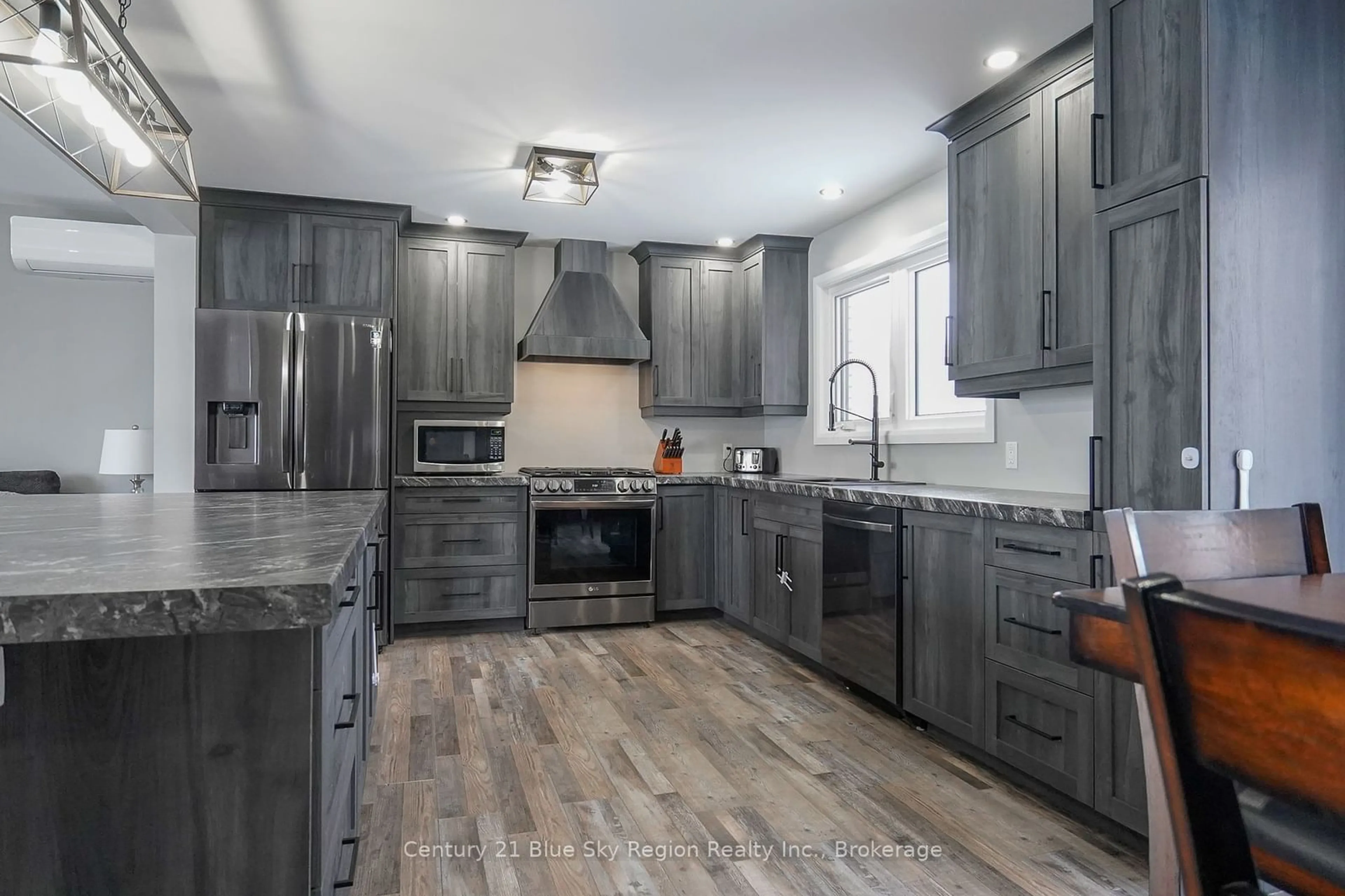 Open concept kitchen, wood/laminate floor for 157 John St, West Nipissing Ontario P2B 1Z7