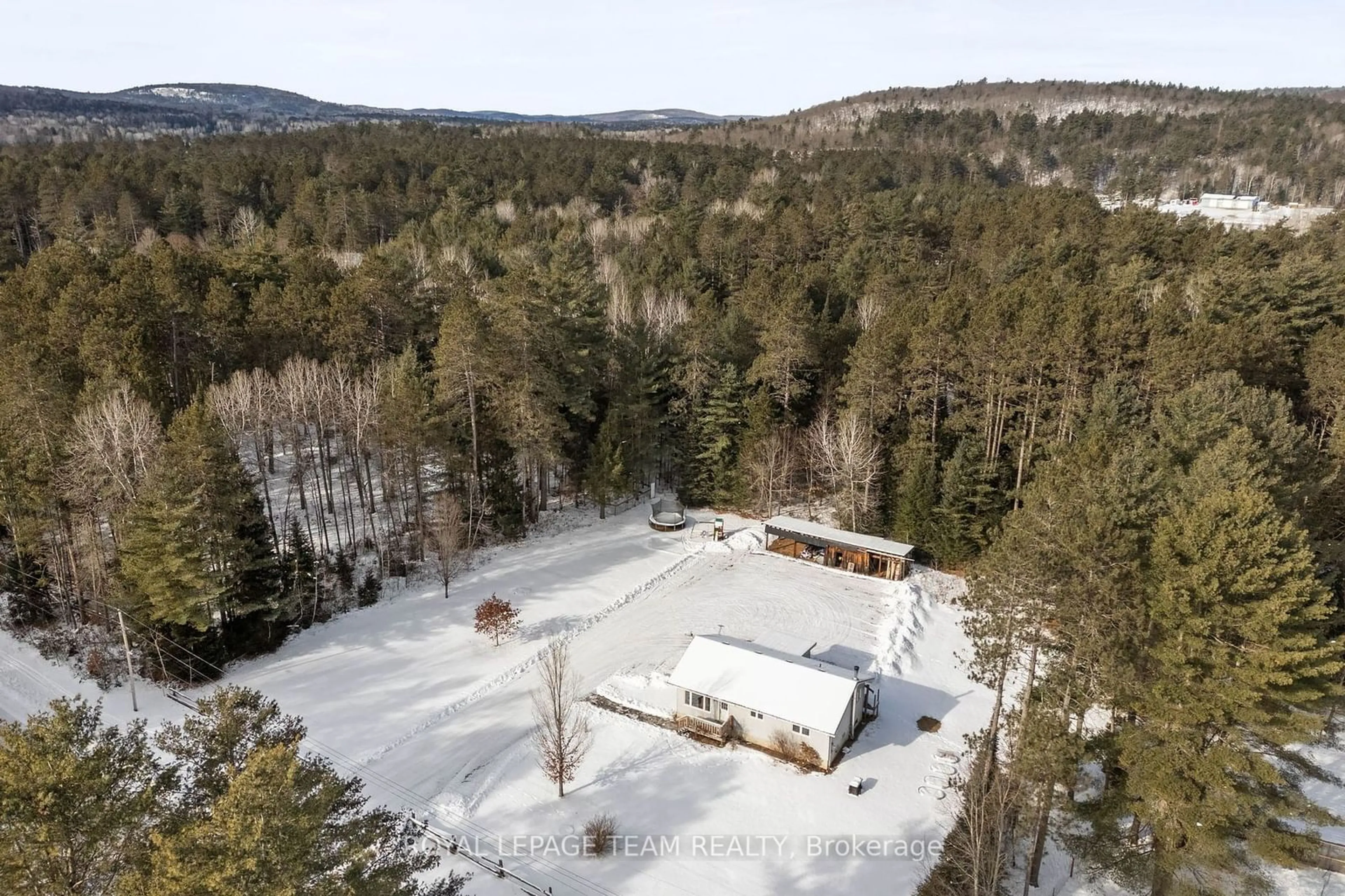 A pic from outside/outdoor area/front of a property/back of a property/a pic from drone, forest/trees view for 522 Pine St, Greater Madawaska Ontario K0J 2R0