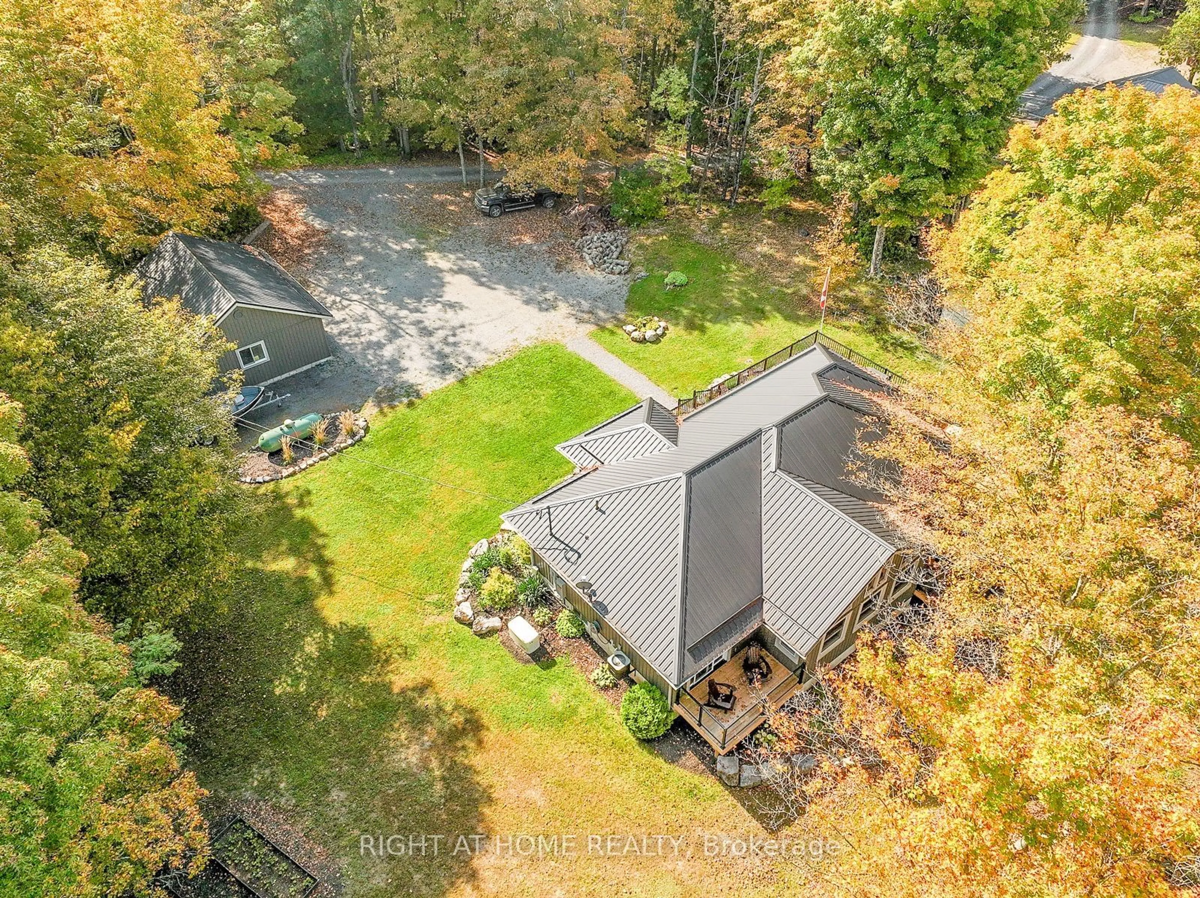 A pic from outside/outdoor area/front of a property/back of a property/a pic from drone, forest/trees view for 98 Cottage Lane, Greater Napanee Ontario K0K 2L0