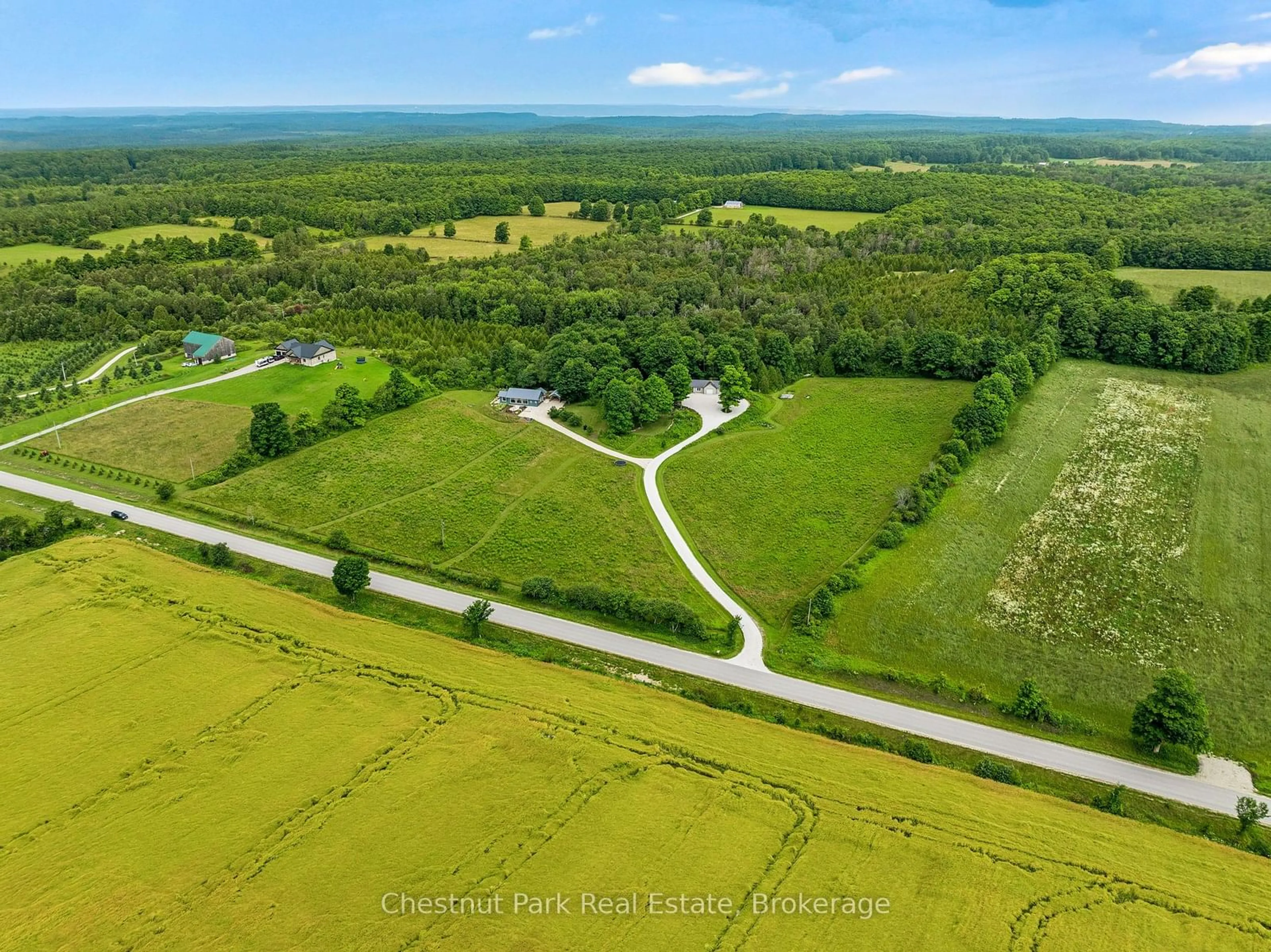 A pic from outside/outdoor area/front of a property/back of a property/a pic from drone, water/lake/river/ocean view for 468147 12th Concession B, Grey Highlands Ontario N0C 1C0