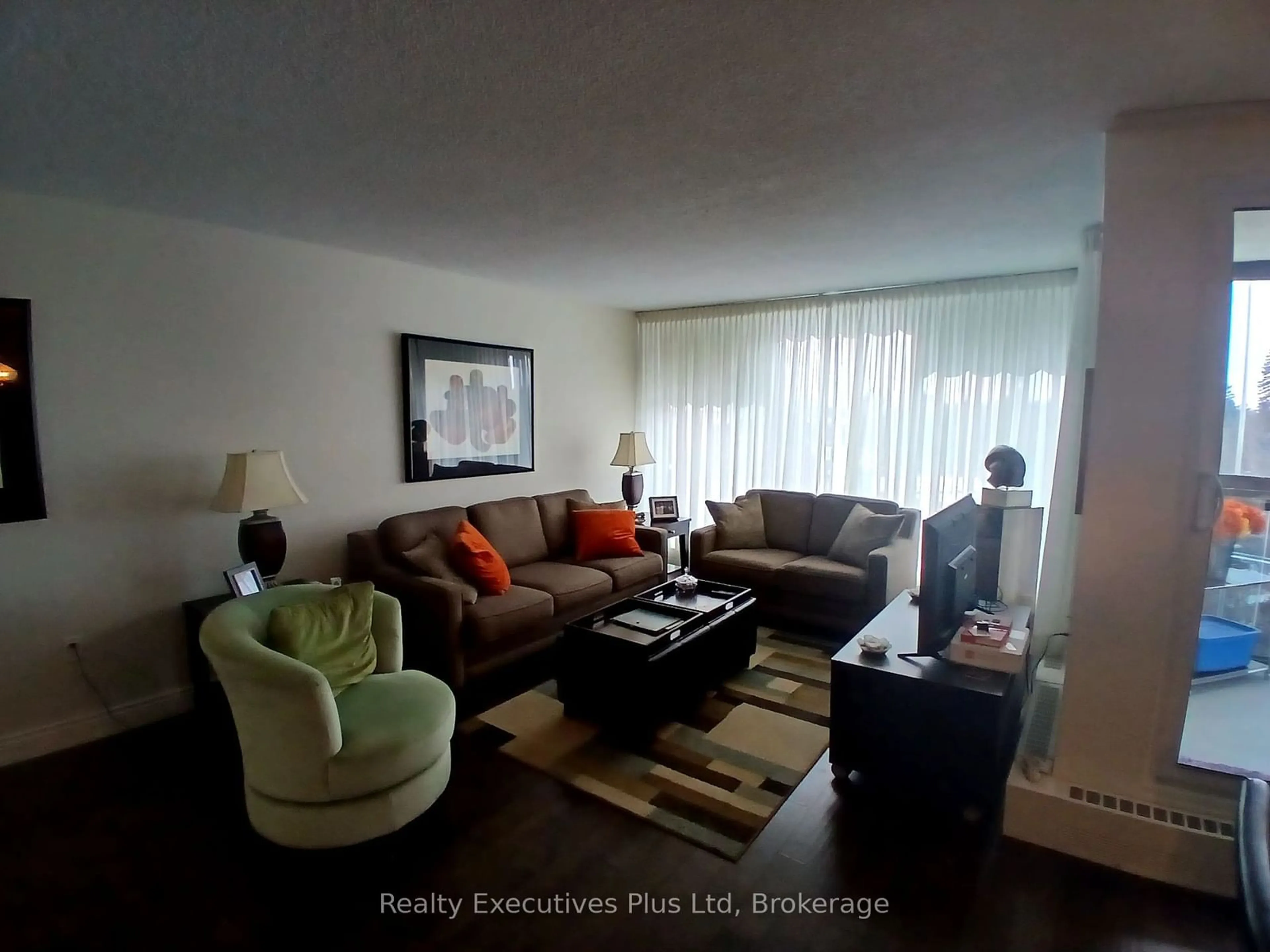 Living room with furniture, wood/laminate floor for 19 Woodlawn Rd #704, Guelph Ontario N1H 7B1