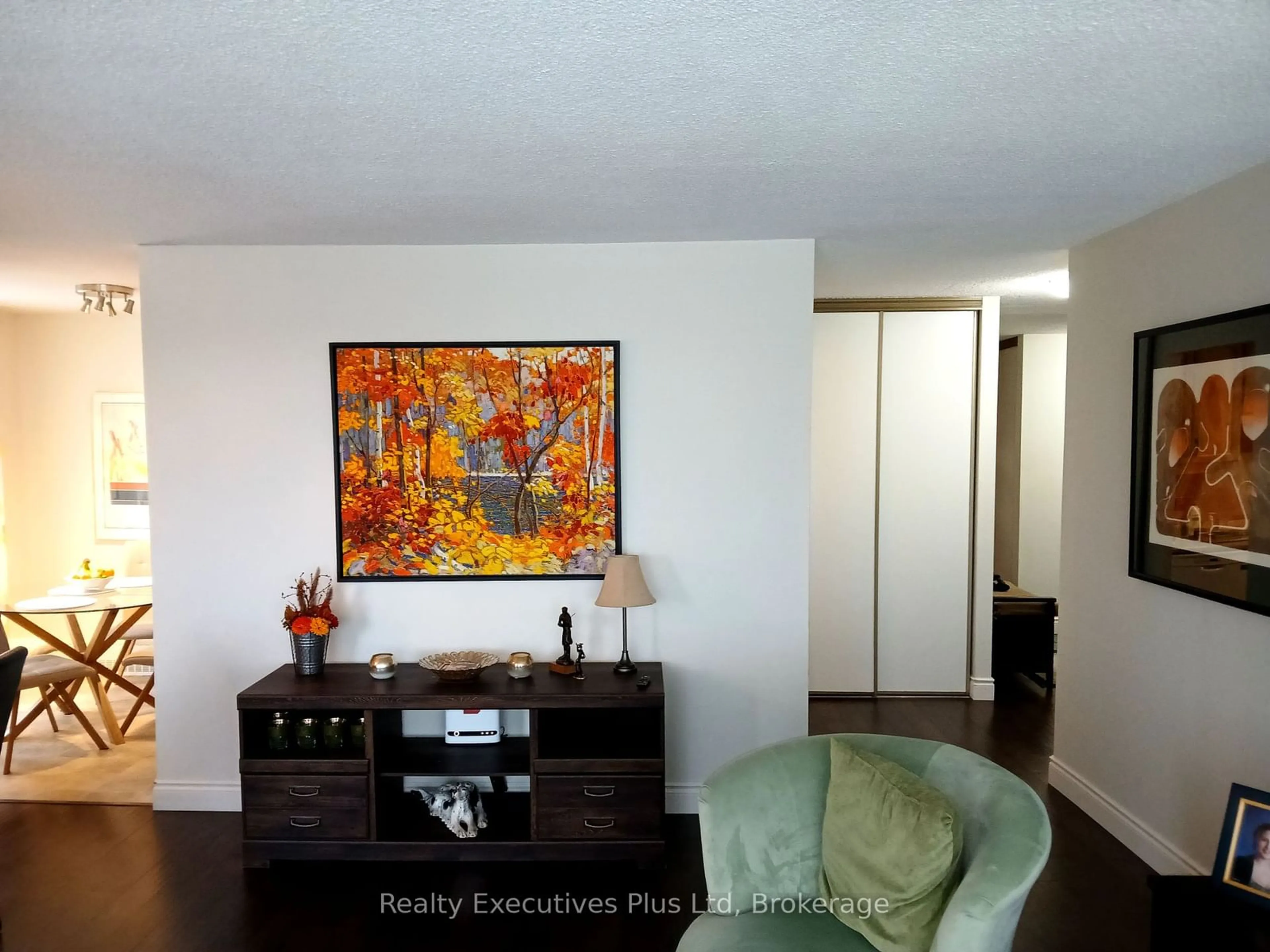 Living room with furniture, wood/laminate floor for 19 Woodlawn Rd #704, Guelph Ontario N1H 7B1