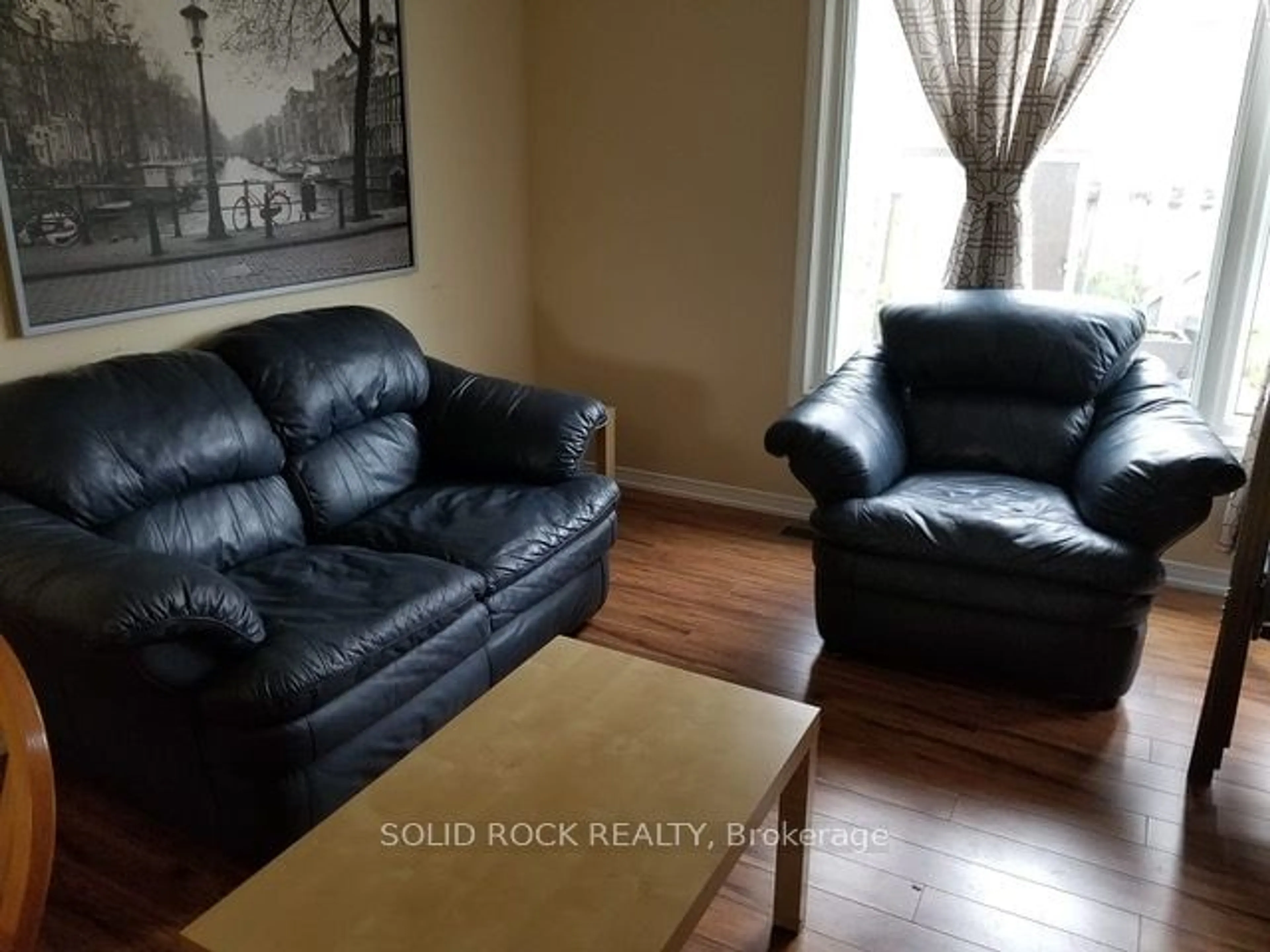 Living room with furniture, wood/laminate floor for 12 Glencoe St, South of Baseline to Knoxdale Ontario K2H 8S6